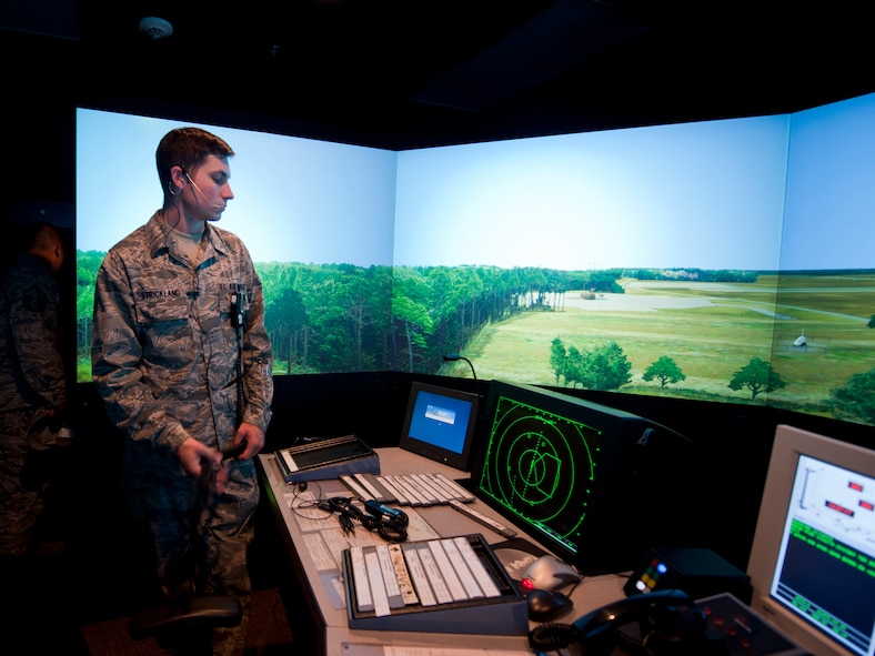 U.S. Air Force Airman 1st Class Glenn Strickland, 23rd Operations Support Squadron air traffic controller (ATC) apprentice, stands by as a co-worker sets up a Tower Simulator System at Moody Air Force Base, Ga., Aug. 18, 2011. The simulator provides an interactive, realistic training environment for ATCs in a non-operational setting. The system replicates Moody’s flight line and airfield and is designed to simulate all possible weather or flight conditions. (U.S. Air Force photo by Staff Sgt. Jamal D. Sutter/Released)