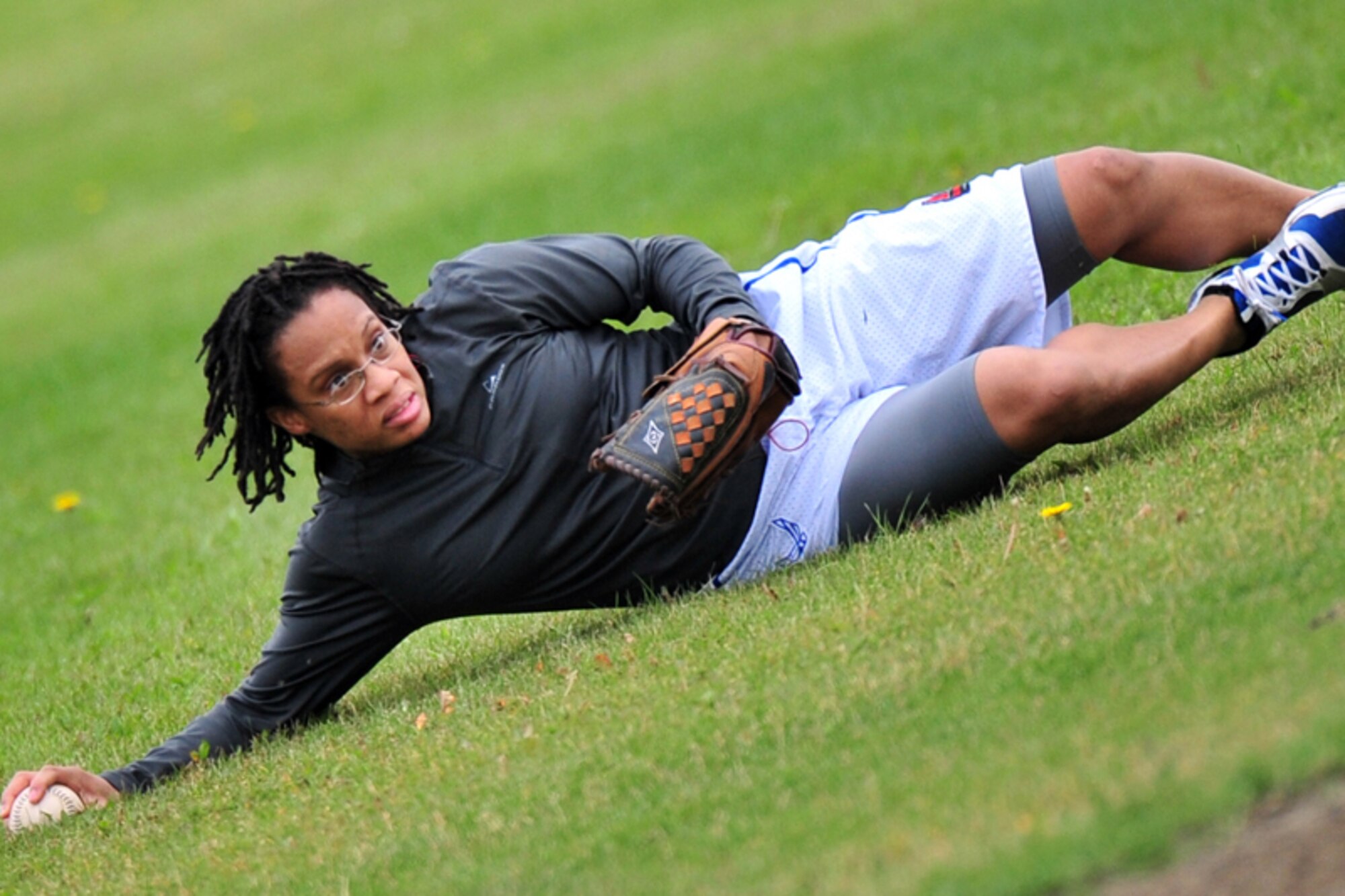 USARAK’s Denasha Mondy, 673d Force Support Squadron, of Louisville, Ky., makes a sliding catch during the game.    (U.S. Air Force photo/Justin Connaher)