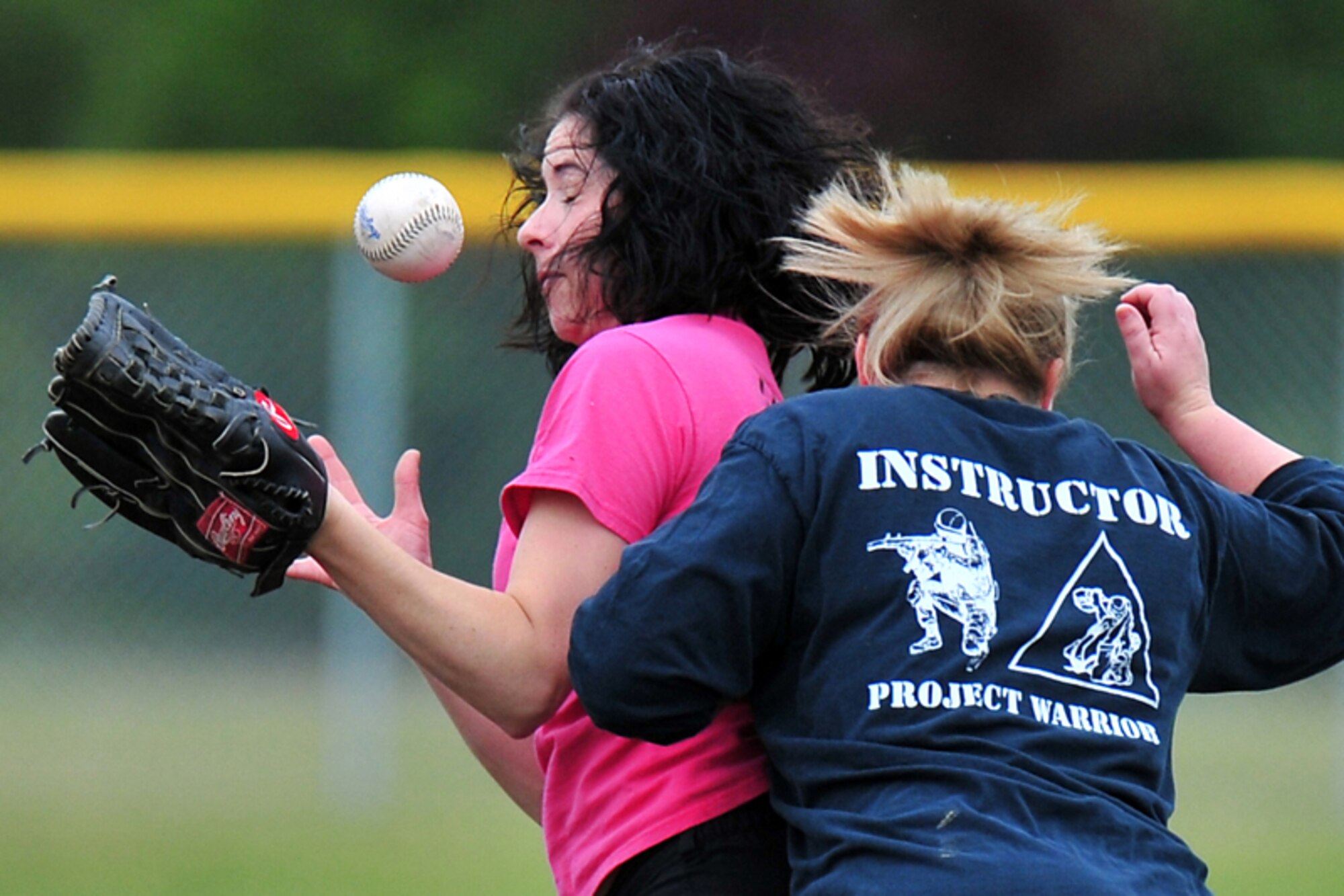 “1st Ladies” Cherie Taylor (in pink) tries to catch the ball as she and  USARAK’s Kim Walker collide at second base during the Womens’ Intramural Softball Championship semi-final game between 1st Battalion (Airborne) 501st Infantry Regiment and U.S. Army-Alaska at the Buckner Physical Fitness Center Field Saturday.  (U.S. Air Force photo/Justin Connaher)
