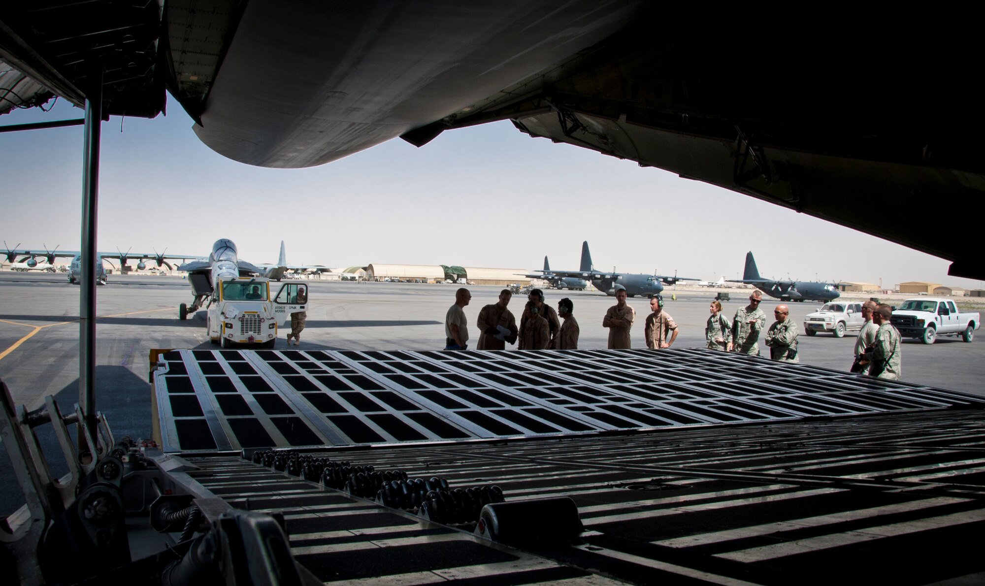 KANDAHAR AIRFIELD, Afghanistan -- Members of the 451st Expeditionary Logistics Readiness Squadron aerial port flight and 22nd Airlift Squadron look over the load plan as they prepare to load an F/A-18 Super Hornet onto a C-5 Galaxy here Aug. 18, 2011. This marked the first time the C-5 had been used to transport the F/A-18 back to the United States. After months of coordination and planning, senior leaders at the Navy’s Naval Air Forces and the Air Force’s Air Mobility Command approved a plan to transport the aircraft back to its home station at Naval Air Station North Island near San Diego, Calif. (U.S. Air Force photo by Senior Airman David Carbajal)