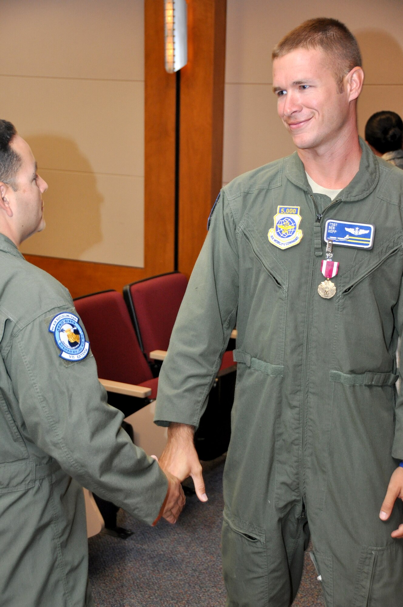 Tech Sgt. Ben Hopp, former 6th Air Refueling Squadron training flight chief and KC-10 instructor flight engineer, greets fellow Airmen after recieving the Henry E. "Red" Erwin Award for outstanding career enlisted aviator of the year Aug. 12. (U.S. Air Force photo/Staff Sgt.Timothy Boyer)