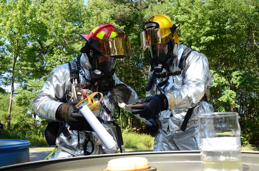 Maryland Air National Guard firefighters Edmond Schwartz and Jason Nahorney take a reading from a multi-gas detector during a Hazardous Material exercise.  On August 12, 2011 Maryland National Guardsmen, along with members of the Coast Guard Baltimore Sector, and local emergency service members conducted a civil/military disaster drill at Warfield Air National Guard Base. (Photo taken by TSgt. Chris Schepers/Released)