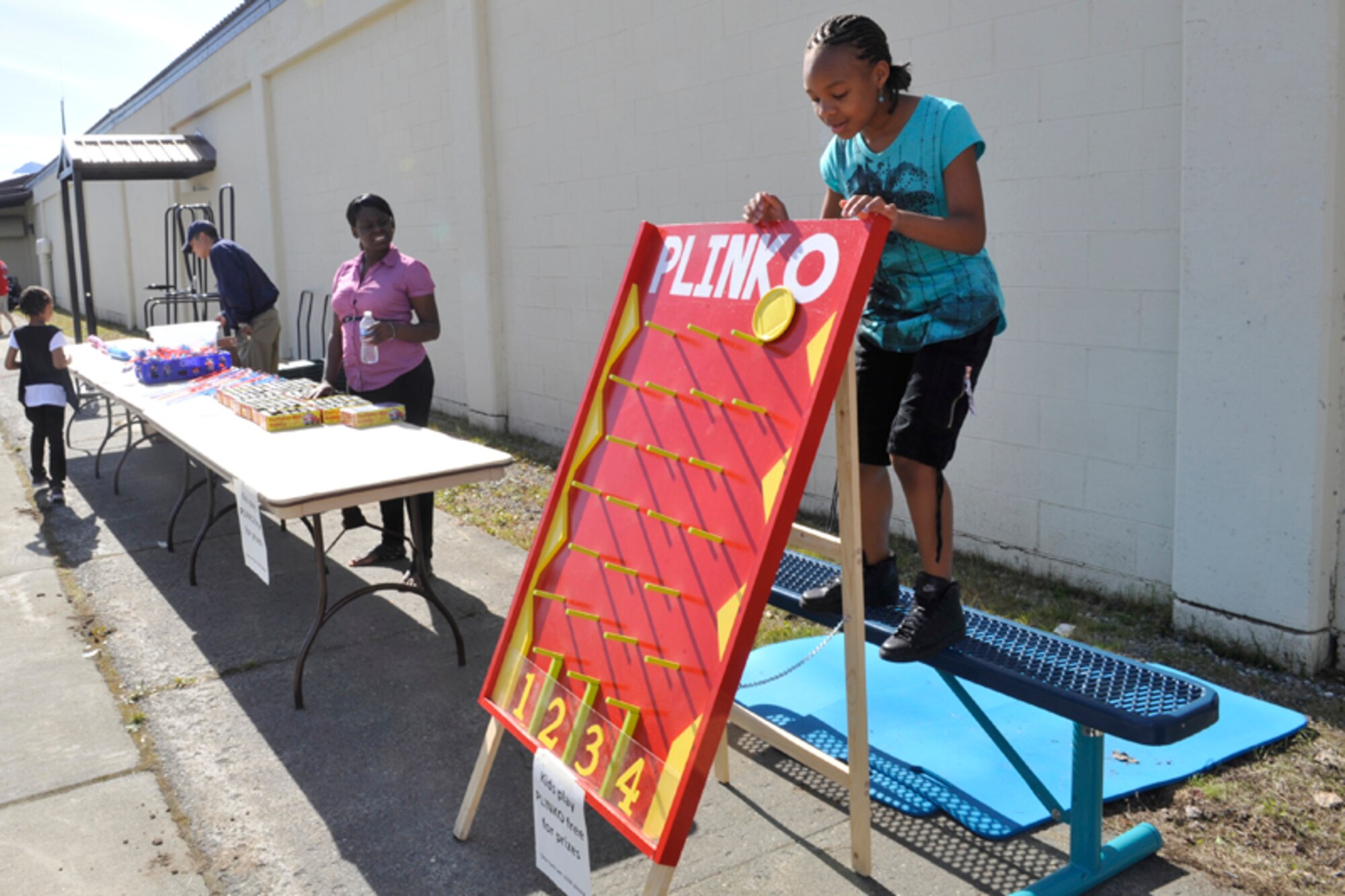 Amir’a S. Edmond plays Plinko at the Back to School Bash. Children could win cotton
candy, bubbles, and stickers by winning the game, which was just one of many attractions at the Back to School Bash. (U.S. Air Force photo/Airman 1st Class Ty-Rico Lea)