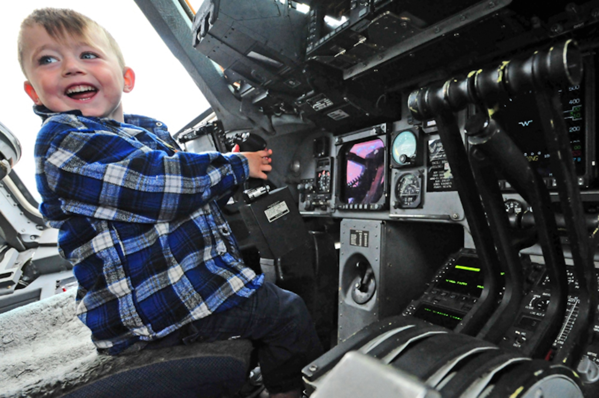 L.J. Hall, 5, plays pilot in the cockpit of a C-17 Globemaster III at the Joint Mobility Complex. Hall’s father is Army Sgt. Carey Hall, 1st Squadron (Airborne) 40th Cavalry Regiment, of Fort Worth, Texas.  (U.S. Air Force photo/Justin Connaher)