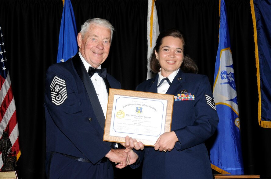 McGHEE TYSON AIR NATIONAL GUARD BASE, Tenn. - Tech. Sgt. Stephanie R. Spiegel, right, receives the distinguished graduate award for NCO Academy Class 11-6 at The I.G. Brown Air National Guard Training and Education Center here from retired Chief Master Sgt. of the Air Force Robert D. Gaylor, Aug. 3, 2011.  The distinguished graduate award is presented to students in the top ten percent of the class.  It is based on objective and performance evaluations, demonstrated leadership, and performance as a team player. (U.S. Air Force photo by Master Sgt. Kurt Skoglund/Released)