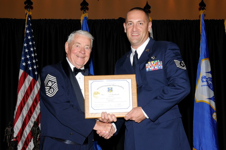 McGHEE TYSON AIR NATIONAL GUARD BASE, Tenn. - Tech. Sgt. Craig S. Frydrych, right, receives the distinguished graduate award for NCO Academy Class 11-6 at The I.G. Brown Air National Guard Training and Education Center here from retired Chief Master Sgt. of the Air Force Robert D. Gaylor, Aug. 3, 2011.  The distinguished graduate award is presented to students in the top ten percent of the class.  It is based on objective and performance evaluations, demonstrated leadership, and performance as a team player. (U.S. Air Force photo by Master Sgt. Kurt Skoglund/Released)