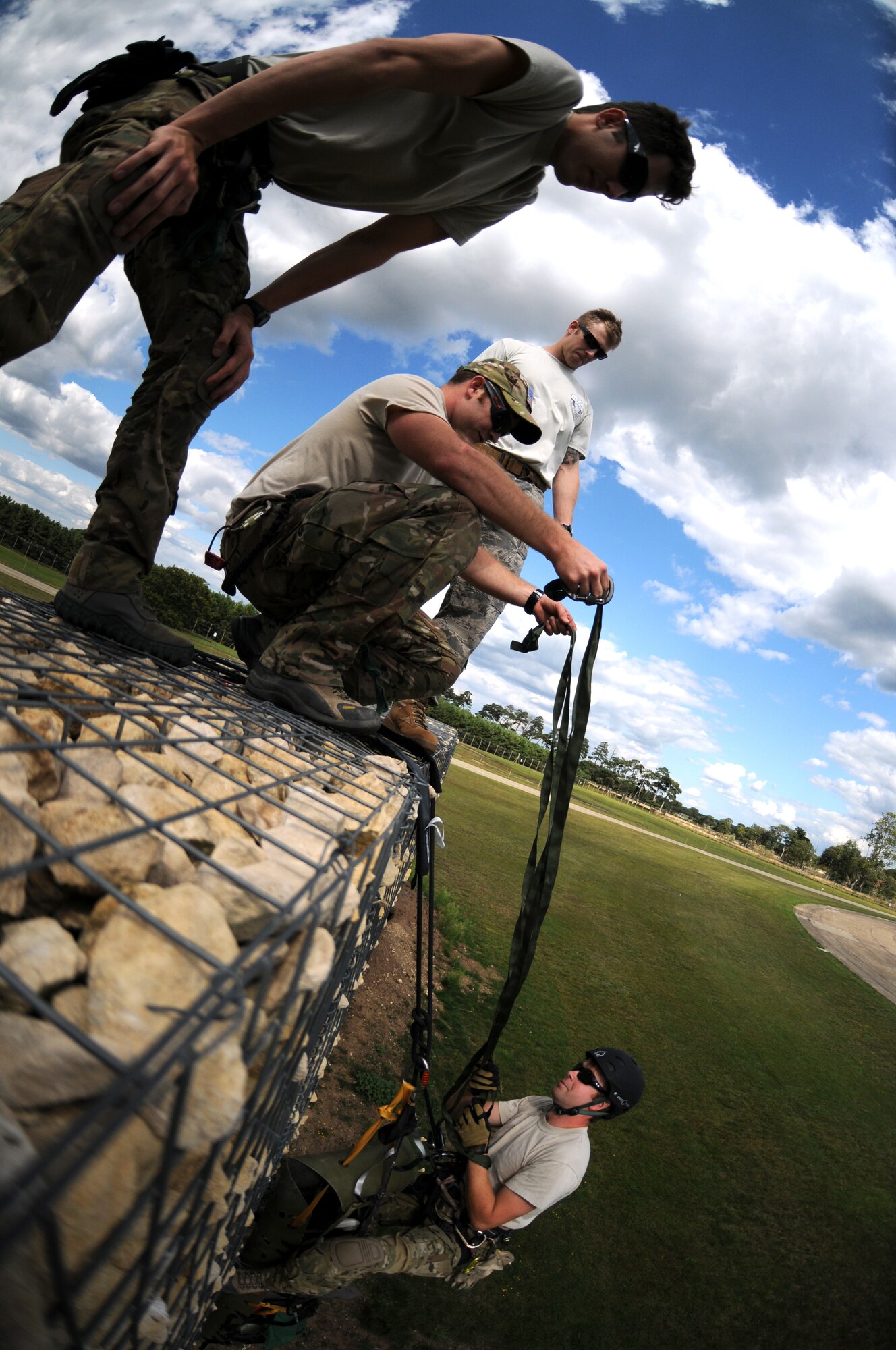 ROYAL AIR FORCE LAKENHEATH, England - Pararescuemen from the 56th Rescue Squadron raises a mock patient during mountain rescue training on RAF Lakenheath, Aug. 15, 2011. Pararesecuemen must train to recover and safely remove patients from any situation, time or place. The 56th RQS is a combat-ready search and rescue squadron of HH-60G Pave Hawk helicopters capable of executing all-weather search and rescue missions day or night in hostile environments. (U.S. Air Force photo/Airman Cory Payne)