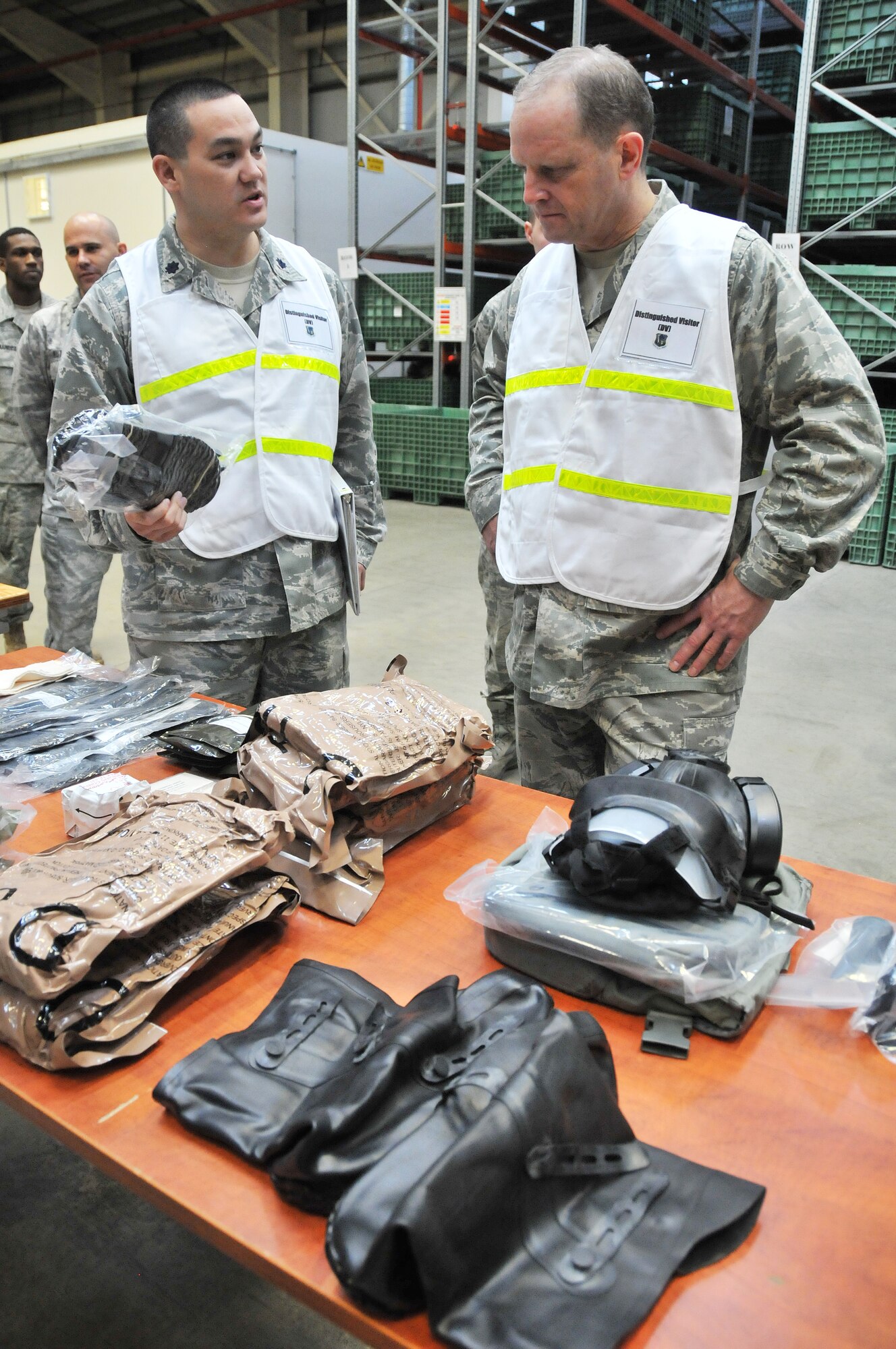 ROYAL AIR FORCE LAKENHEATH, England – Lt. Col. Adrian Crowley (left), 48th Logistics Readiness Squadron commander, shows chemical gear bags that are issued out to deploying Airmen to Maj. Gen. Jay Lindell, Headquarters U.S. Air Force, Washington, D.C., Global Power Programs director, Office of the Assistant Secretary of the Air Force for Acquisition, Aug. 12, 2011. Lindell toured the deployment center and other base facilities to meet with Liberty Wing Airmen. Lindell also attended this year’s combat dining-in as the guest speaker.  (U.S. Air Force photo/Senior Airman Lausanne Morgan)