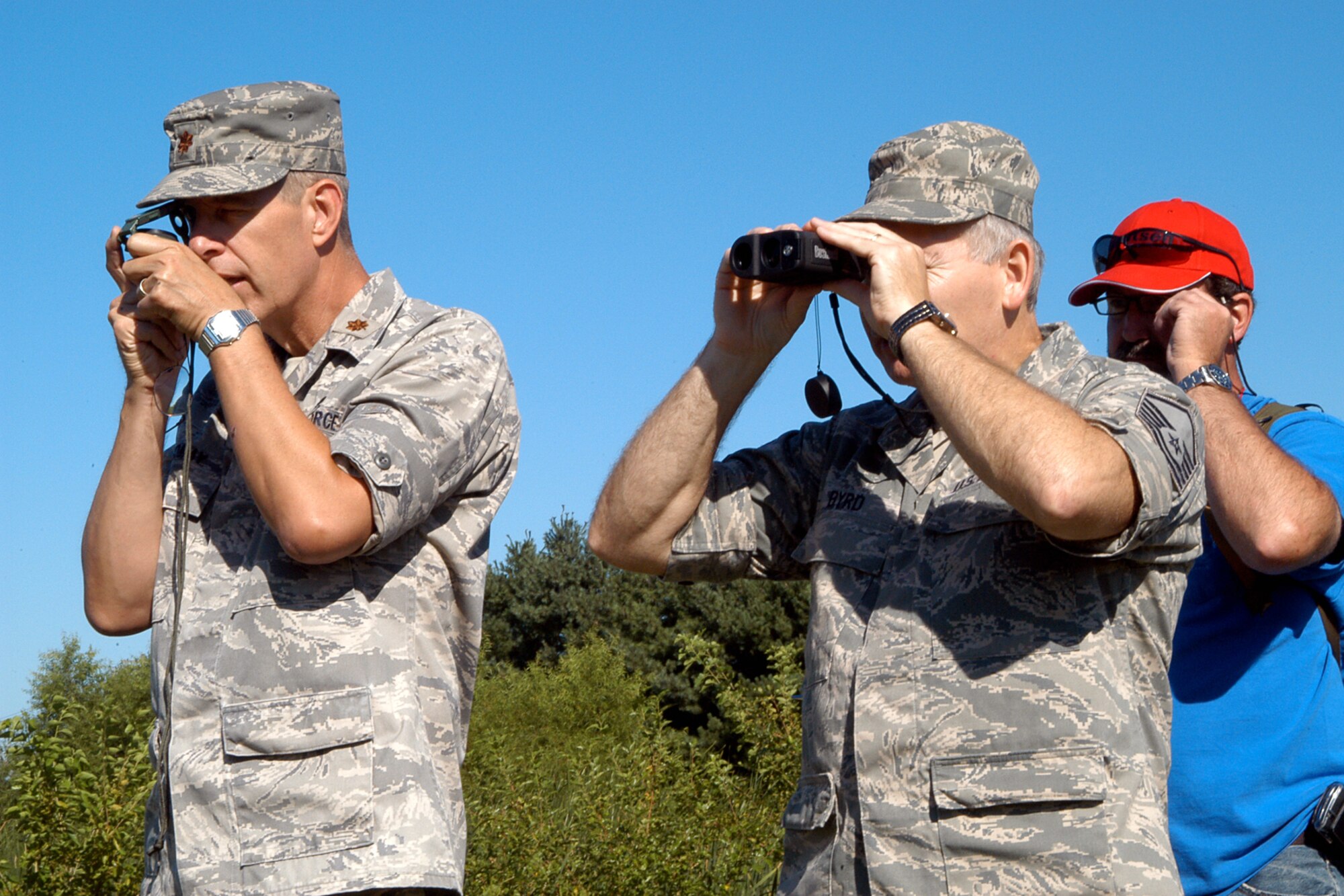 GRISSOM AIR RESERVE BASE, Ind. -- Maj. Toomay, 434th Maintenance Group maintenance officer, and Master Sgt. Richard Byrd, 434th Maintenance Operations Flight maintenance scheduler, utilize a compass and laser rangefinder during land navigation training here Aug. 11. Grissom emergency management conducted a map reading class for emergency management readiness support team members, who would be activated in the event of an emergency to provide additional support to first responders. (U.S. Air Force photo/Senior Airman Andrew McLaughlin)                                