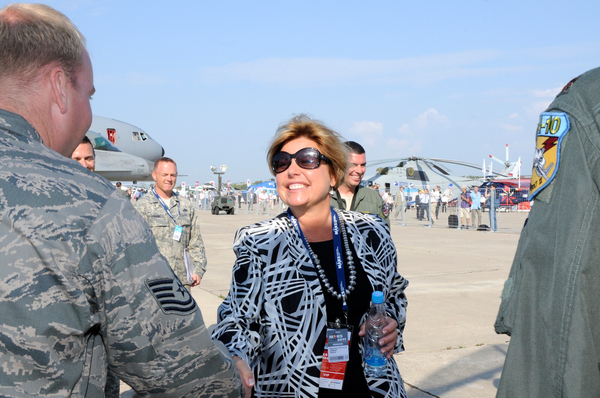 Ms. Hedi Grant, Secretary of the Air Force International Affairs, shakes hands with Tech. Sgt. Danny Turner, 81st Aircraft Maintenance Squadron, during her tour of the U.S. European Command's area at the Moscow International Aviation and Space Salon, or MAKS 2011, Aug. 17. MAKS is one of the premier events of its type in the world and Department of Defense participation demonstrates the United States commitment to international security, promotes international cooperation, and contributes to U.S. foreign policy objectives.  The U.S. Air Force has a KC-10 Extender, two F-16C Fighting Falcons, two A-10 Thunderbolt II, one F-15E Strike Eagle, one B-52 Stratotanker, C-130J Super Hercules and C-5M Galaxy statics for the show. 