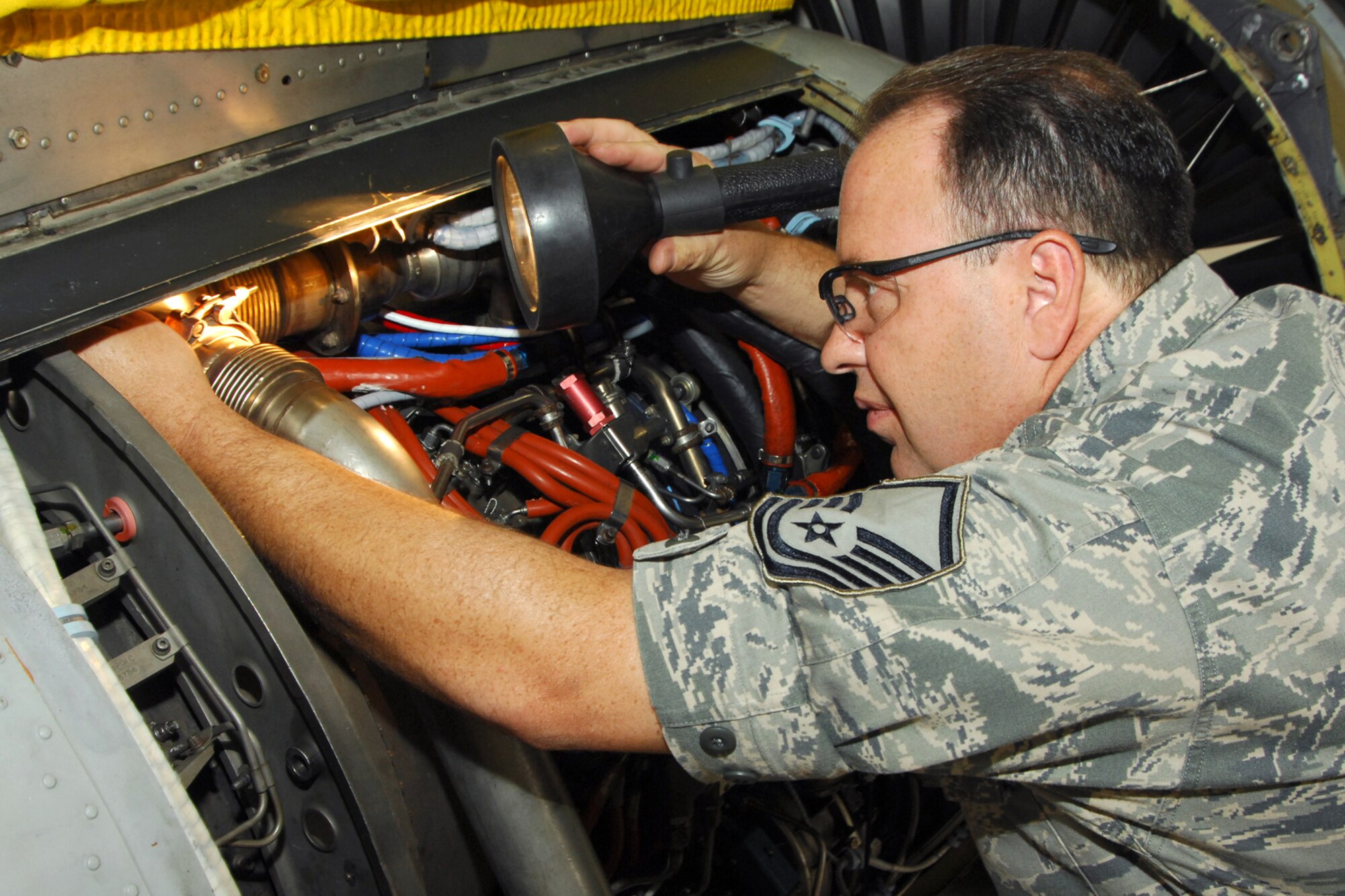 Master Sgt. Adrian Canchola works on a jet engine from an A-10 Thunderbolt II attack aircraft at Selfridge Air National Guard Base., July 27, 2011. The engine generates about 9,000 pounds of thrust. (USAF photo by John S. Swanson)