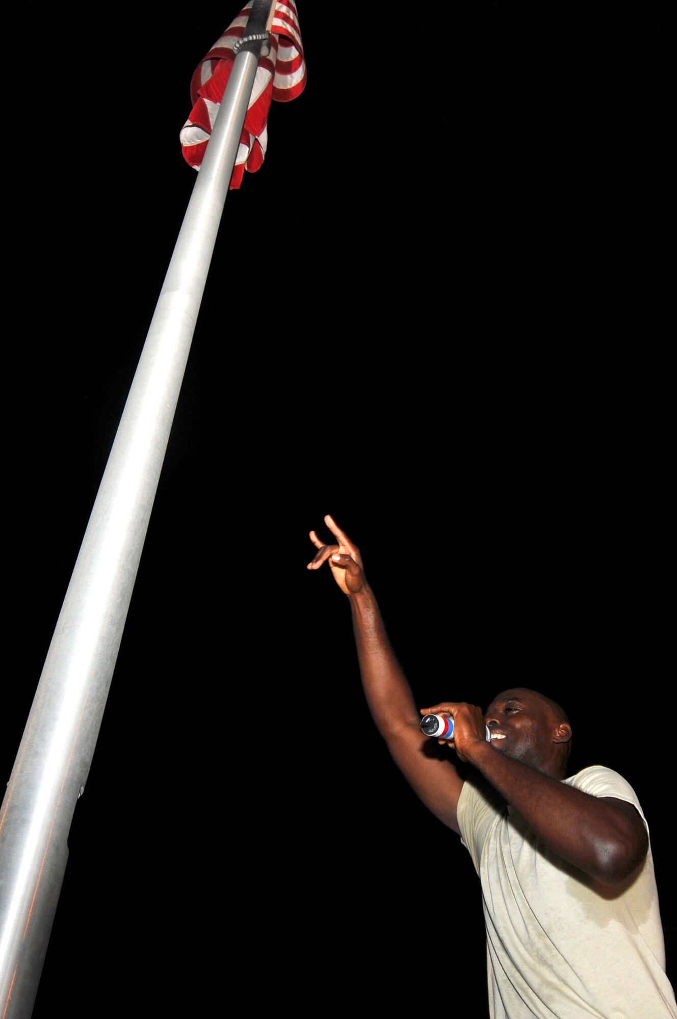 BAGRAM AIRFIELD, Afghanistan – Staff Sgt. Brian Owens Air Forces Central Public Affairs band “Sidewinder” vocalist performs at the flag pole in Camp Cunningham Bagram Afghanistan, Aug. 14.  The band played multiple shows each day to allow as many people as possible to attend the events. (U.S. Air Force photo/ Senior Airman Krista Rose) 