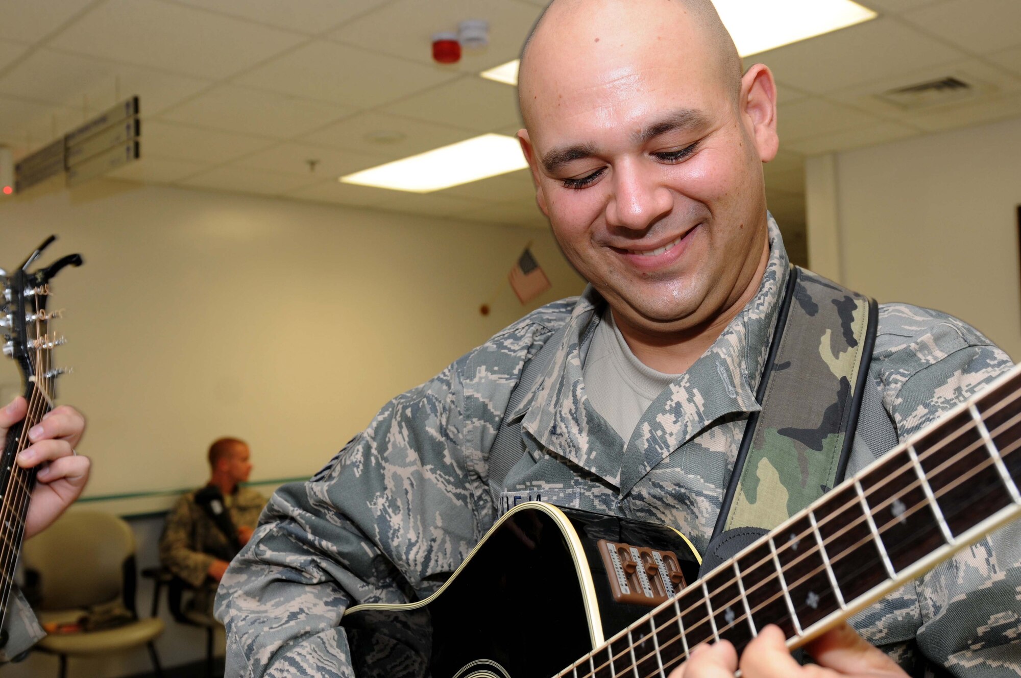 BAGRAM AIRFIELD, Afghanistan – Tech. Sgt. Joseph Castilleja Air Forces Central Public Affairs band “Sidewinder” guitarist performs at the Craig Joint at Bagram Afghanistan, Aug. 14.  The band played multiple shows each day to allow as many people as possible to attend the events. (U.S. Air Force photo/ Senior Airman Krista Rose) 