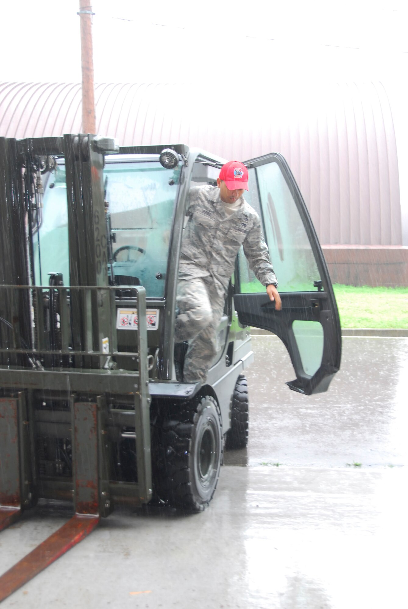 OSAN AIR BASE, Republic of  Korea -- Staff Sgt. Josh Perez, 254th RED HORSE heavy equipment operator, exits a forklift after moving supplies in Rush Park life sustainment center on Osan Air Base, Republic of Korea.  The REDHORSE sustainment team of ten is responsible for setup and maintaining the facilities in Rush Park commonly refered to as tent city in support of Ulchi Freedom Guardian 2011. (U.S. Air Force photo/Master Sgt. Kimberly Spinner)
