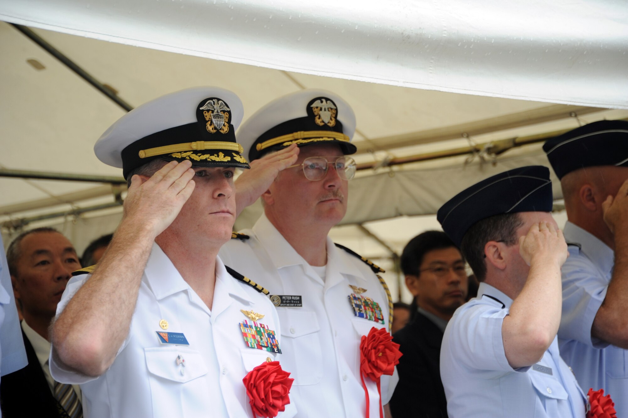 Misawa, Japan (Aug. 18, 2011) - Naval Air Facility Misawa Commanding Officer Capt. Christopher Rodeman (left,) and Commander Naval Forces Japan Chief of Staff Capt. Peter Rush salute as the national anthem is played during a ceremony commemorating the 80th anniversary of the first nonstop transpacific flight. Miss Veedol, a 1931 Bellanca Skyrocket J-400, departing from Misawa and landing in East Wenatchee Wash., was the first aircraft to fly across the Pacific Ocean nonstop. (U.S. Navy photo by Mass Communication Specialist 1st Class Matthew M. Bradley/Released)