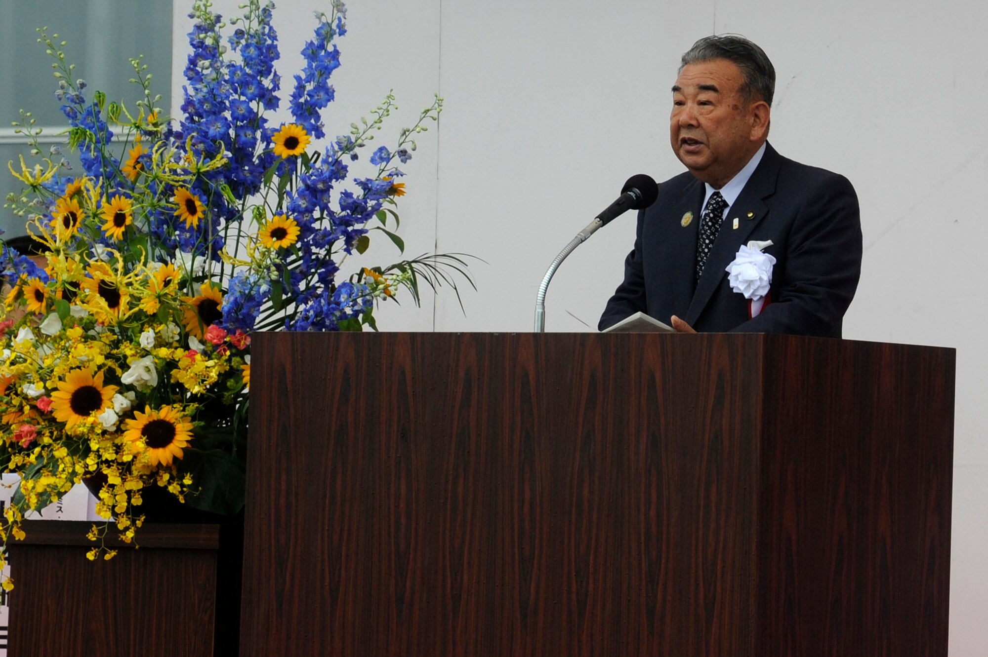 MISAWA, Japan -- The Honorable Taneichi Kazumasa, Misawa City mayor, gives opening remarks during the Miss Veedol Flight 80th Anniversary Ceremony held at the Misawa Air and Science Museum Aug. 18. On Oct. 5, 1931, Clyde Pangborn and co-pilot Hugh Herndon took off from Sabishiro Beach in Misawa City and crash landed the plane in the hills of East Wenatchee City in Washington State, after 41 hours of flying. (U.S. Air Force photo/Tech. Sgt. Marie Brown)