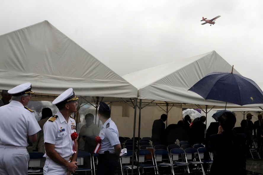 MISAWA, Japan -- Attendees of the Miss Veedol Flight 80th Anniversary Ceremony watch as Miss Veedol makes her commemorative flight over the Misawa Air and Science Museum Aug. 18. The Miss Veedol carried an initial load of 915 gallons of aviation gasoline on her record-breaking flight from Sabishiro Beach, Misawa to Wenatchee, Washington.(U.S. Air Force photo/Tech. Sgt. Marie Brown)