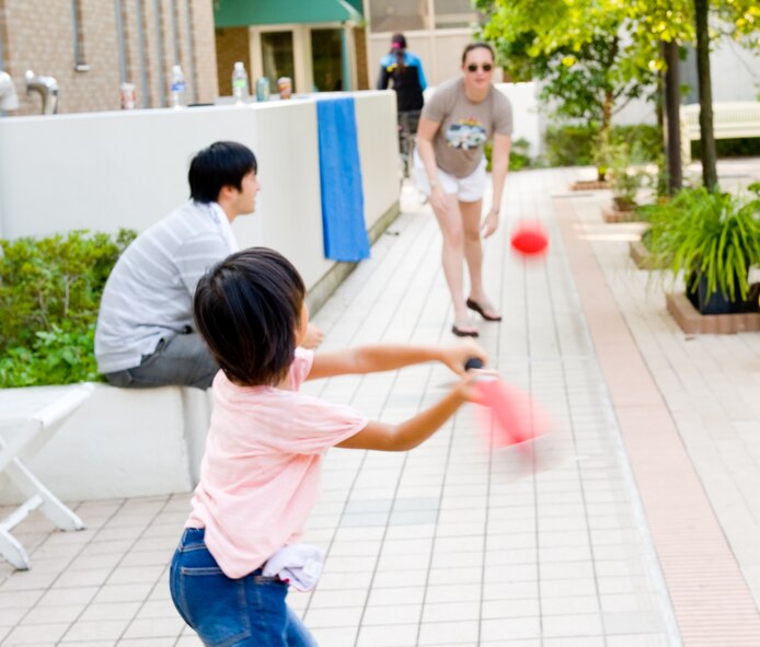 TACHIKAWA, Japan -- An Airman from the 374th Security Forces Squadron plays baseball with a child from the Shisei Gakusha children's home at Tachikawa, Japan, Aug. 16, 2011. 374th SFS Airmen from Yokota Air Base, Japan, donated toys, clothing and food for the children, in an act of good will towards their off-base neighbors . (U.S. Air Force photo/Airman 1st Class Krystal M. Garrett)