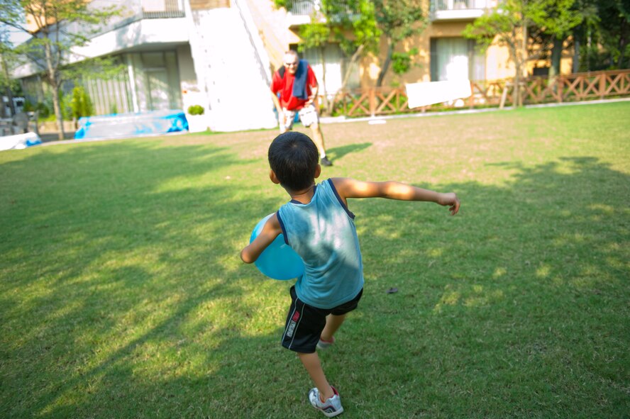 TACHIKAWA, Japan -- A child from the Shisei Gakusha children's home kicks a ball to an Airman from the 374th Security Forces Squadron in Tachikawa, Japan, Aug. 16, 2011. 374th SFS Airmen from Yokota Air Base, Japan, donated toys, clothing and food for the children, in an act of good will towards their off-base neighbors. (U.S. Air Force photo/Airman 1st Class Krystal M. Garrett)