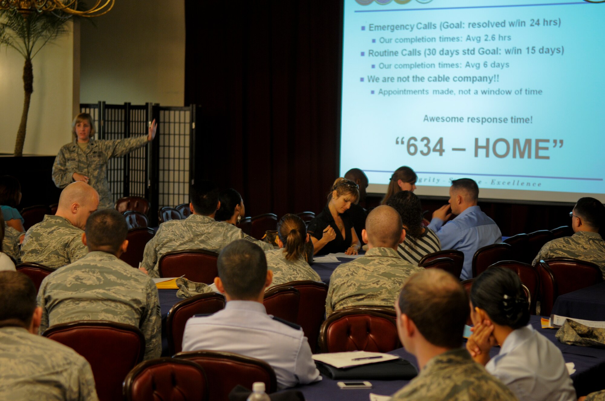 Lt. Col. Ann Birchard, 718th Civil Engineer Squadron commander, gives a housing briefing to newly-arrived service members, Department of Defense civilian employees and their families at the Airman and Family Readiness Center’s newcomers orientation briefing in the Officers’ Club ballroom on Kadena Air Base, Japan, Aug. 17. Despite Kadena going through an Operational Readiness Inspection, the A&FRC is still performing as many services as possible to those stationed on the island. (U.S. Air Force photo/Airman 1st Class Maeson L. Elleman)