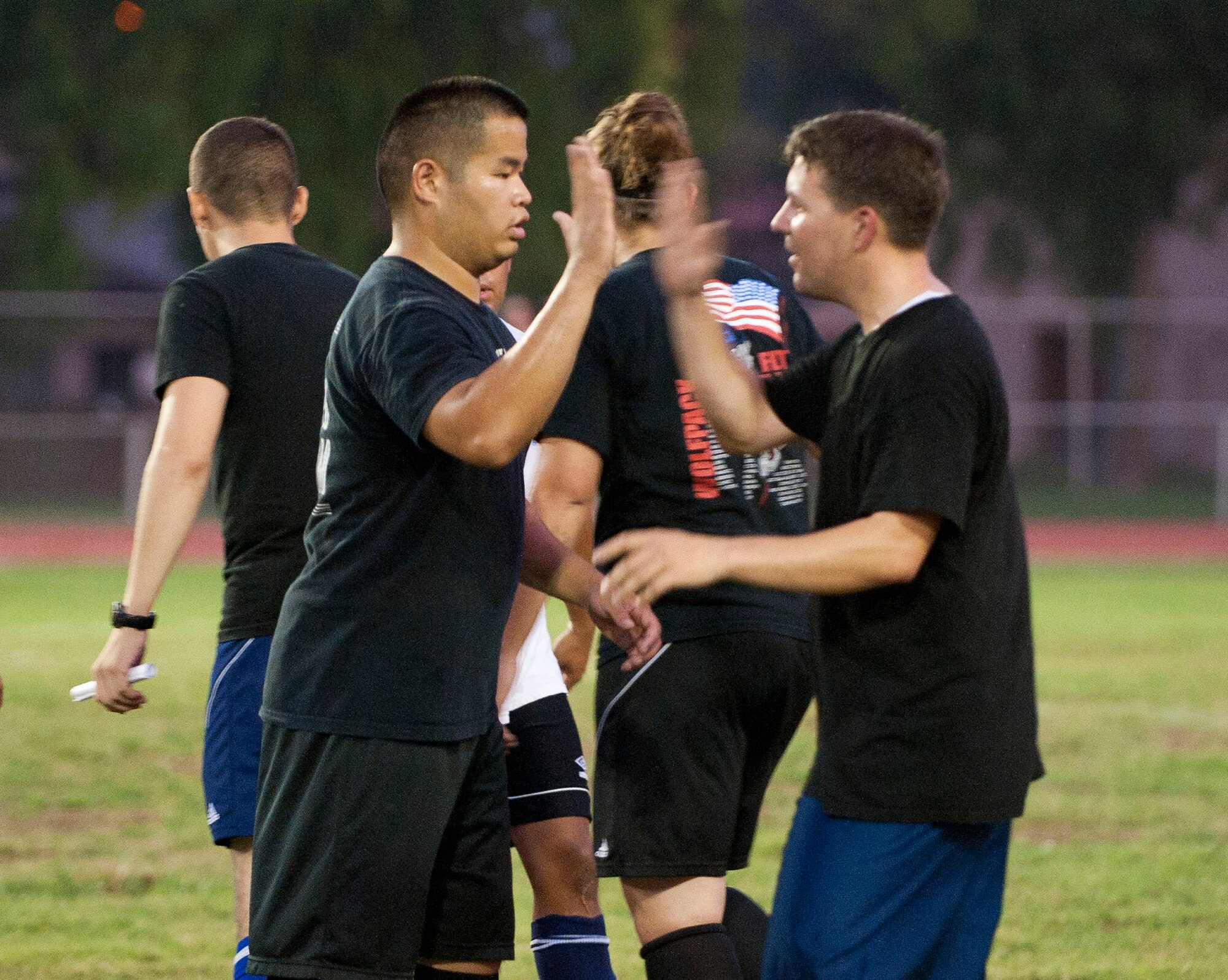 Players from the 39th Maintenance Squadron congratulate each other after their win against the 39th Communications Squadron following their first intramural soccer game of the season Aug. 16, 2011, at Incirlik Air Base, Turkey.  The 39th MXS won the game 1-0. The regular season is scheduled to run through late September. (U.S. Air Force photo by Airman 1st Class Clayton Lenhardt/Released)