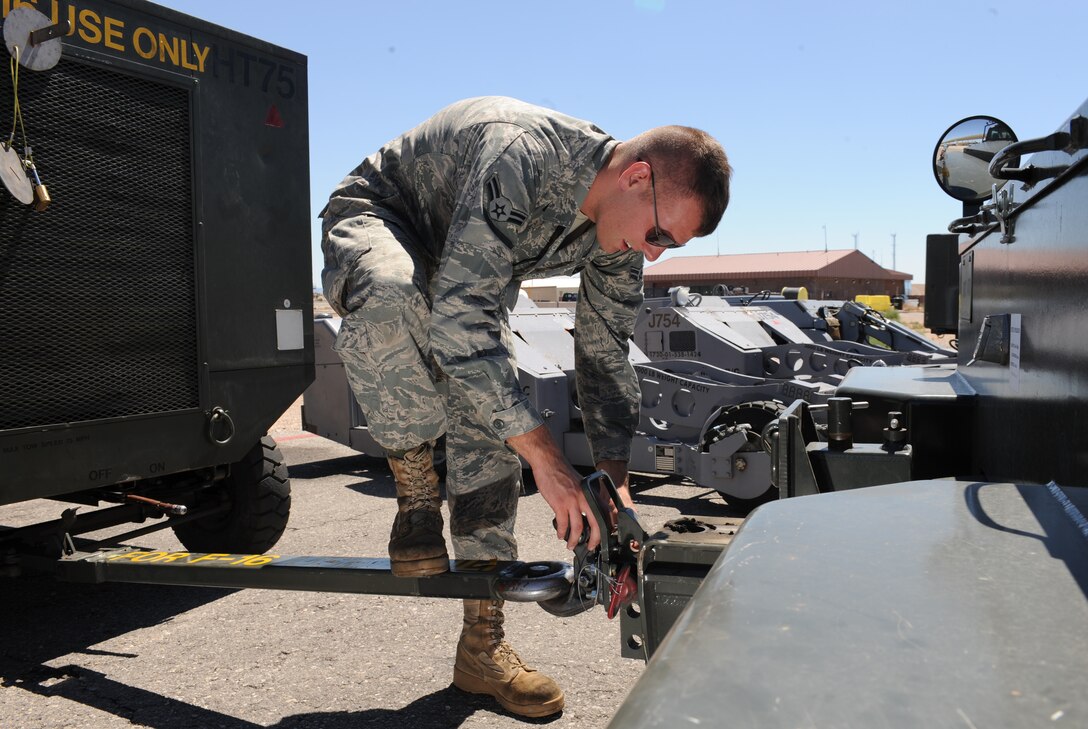 U.S. Air Force Airman 1st Class Nicholas Isham prepares a hydraulic test stand for towing as part of a pre-launch inspection of an F-16 Fighting Falcon during Green Flag West 11-9 on Nellis Air Force Base, Nev., Aug. 15, 2011. Isham is an aerospace ground equipment mechanic assigned to the 20th Aircraft Maintenance Squadron.