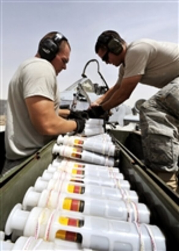 U.S. Air Force Senior Airman Adam Hinojosa (left) and Staff Sgt. Robert Corso (right) load ammunition into an A-10C Thunderbolt II on Kandahar Airfield, Afghanistan, on Aug. 8, 2011.  Hinojosa and Corso are weapons crew members assigned to the 74th Aircraft Maintenance Unit.  