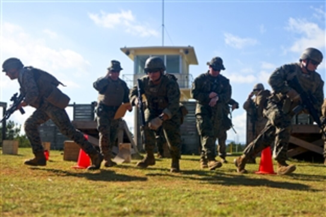 U.S. Marines run to their firing positions during an unknown distance shooting competition at Camp Hansen, Okinawa, Japan, Aug. 17, 2011. The Marines are assigned to Headquarters and Service Company, Battalion Landing Team 2nd Battalion, 7th Marine Regiment, 31st Marine Expeditionary Unit. The unit remains the nation’s force in readiness in the Asia-Pacific region.