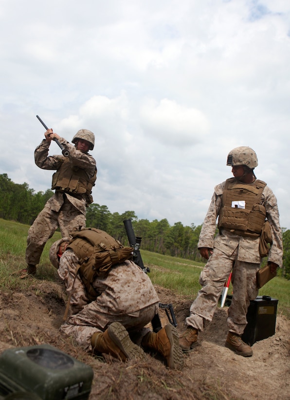 Marines with Charlie Company, 1st Battalion, 2nd Marine Regiment, prepare a 60 mm M-224 Mortar System for firing the next mission during a live-fire range on Camp Lejeune, N.C., Aug. 18, 2011. The training served as an opportunity to maintain the unit’s new mortarmen's skills. The unit is currently scheduled to attach to the 24th Marine Expeditionary Unit.