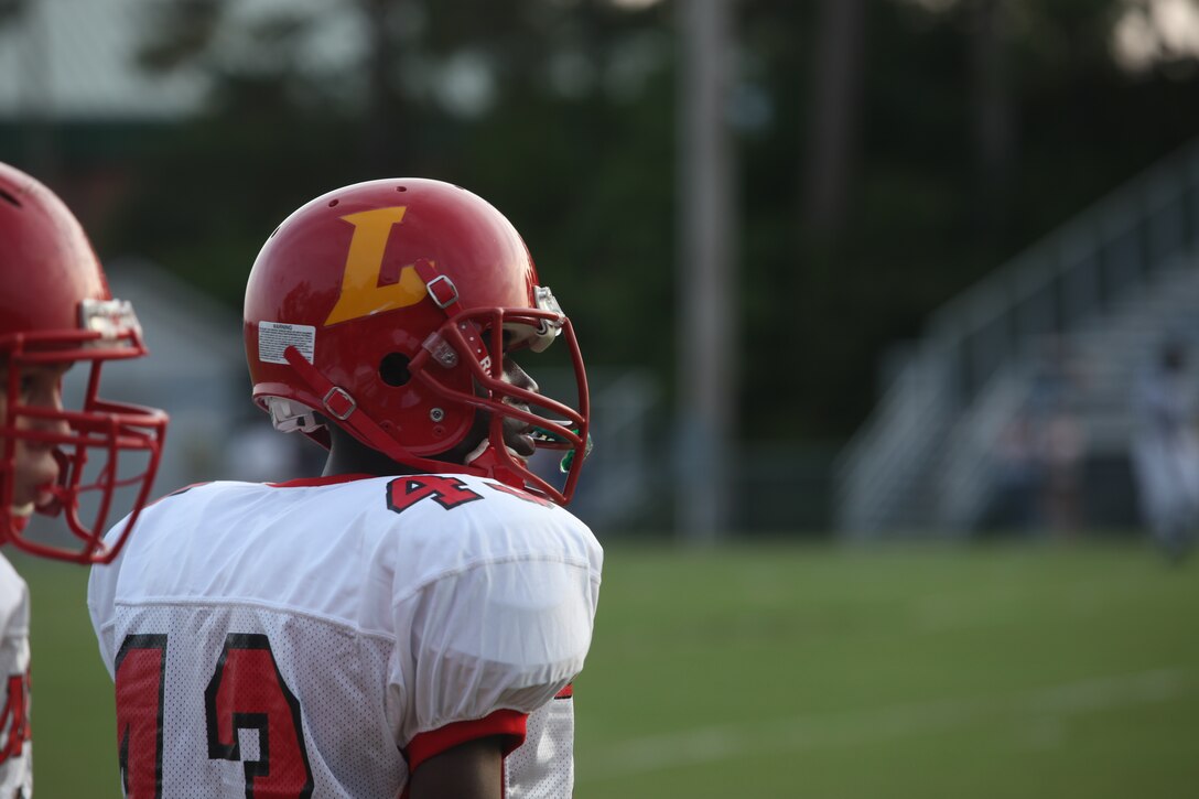 Austin McNeil waits his turn for his portion of the passing warm-ups prior to the Lejeune High School Devil Pups season opener against the Swansboro High School Pirates, Aug. 19. The Pirates beat the Devil Pups 37-28 in a hard-fought game.::r::::n::