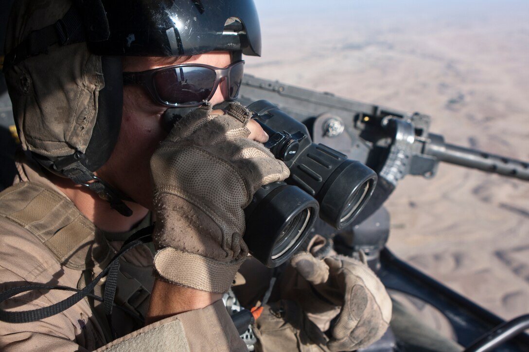 U.S. Marine Corps Sgt. David Parker, a crew chief with Marine Light Attack Helicopter Squadron 267, scans the horizon from a UH-1Y helicopter during a close-air support mission in Helmand province, Afghanistan, Aug. 19, 2011.