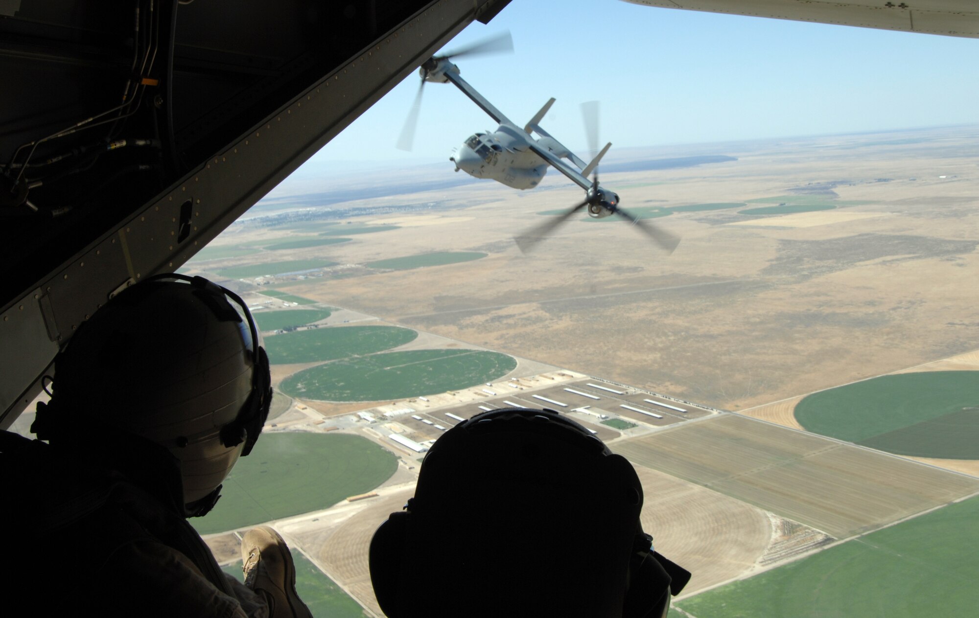 MOUNTAIN HOME AIR FORCE BASE, Idaho – A Marine VM-22 Osprey banks to the left during an “incentive flight,” while two military personnel watch from the back hatch of another MV-22, Aug. 18. The Gunfighters and Marines from Marine Medium Tiltrotor Squadron 166 out of Marine Corps Air Station Miramar, Calif., have been conducting training exercises here since Aug. 9 and will continue until Aug. 25. (U.S. Air Force photo by Senior Airman Benjamin Sutton)