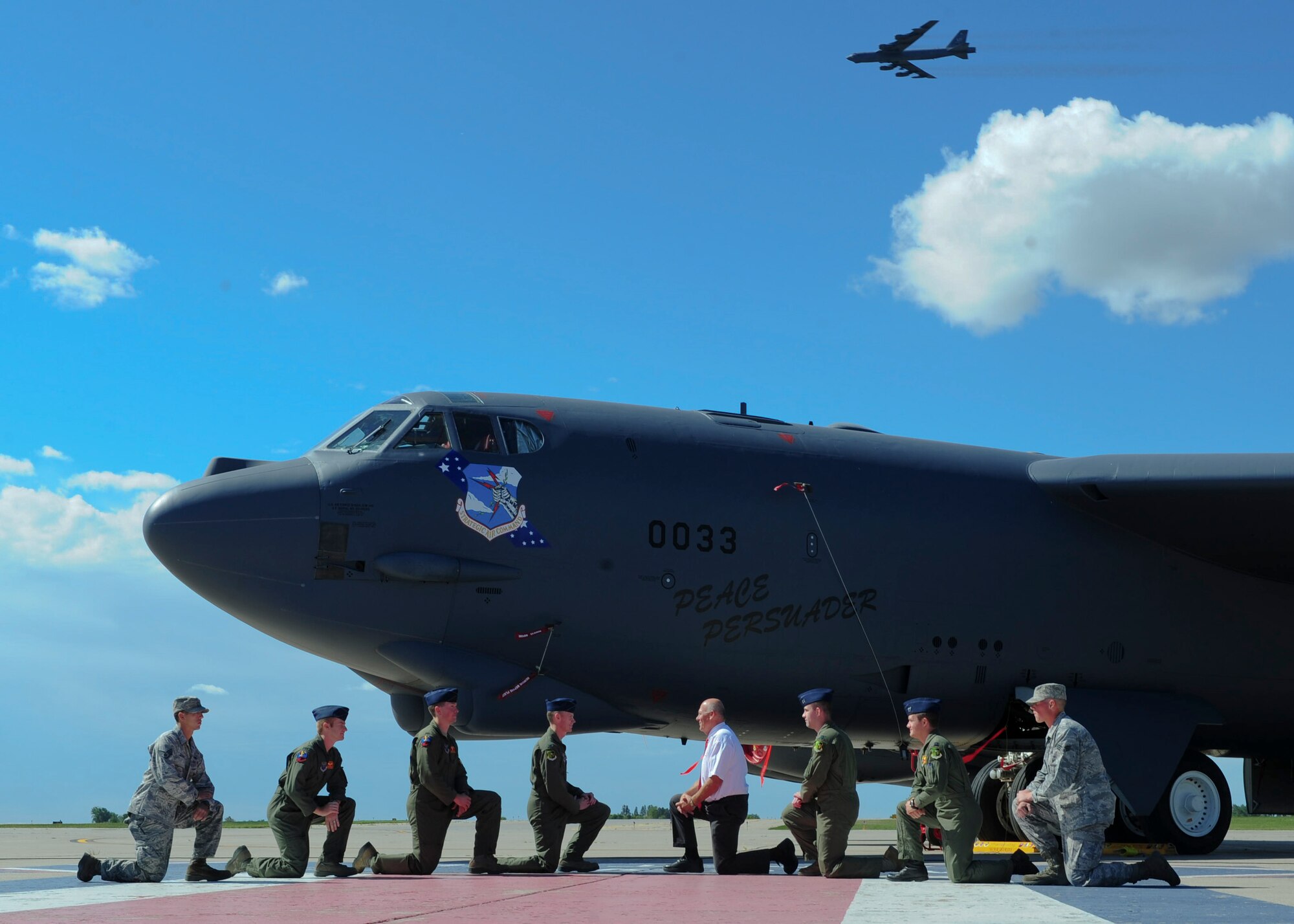 MINOT AIR FORCE BASE, N.D. -- Members of Team Minot recreate a historic photograph of the arrival of the first B-52H Stratofortress here Aug. 19. The B-52, named the “Peace Persuader,” had nostalgic nose art painted on the airframe to celebrate the 50th anniversary of its arrival to Minot AFB. (U.S. Air Force photo/Senior Airman Michael J. Veloz)