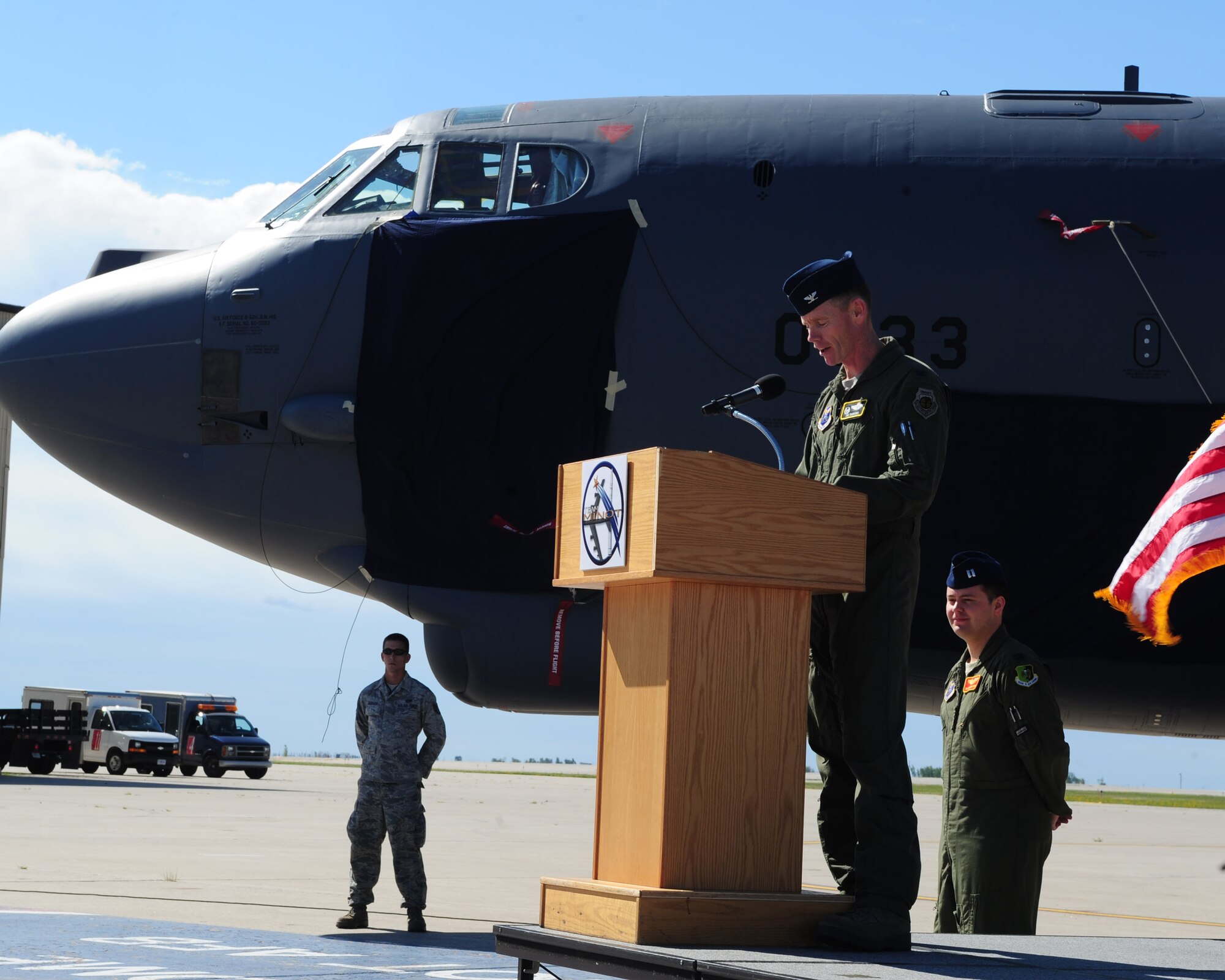 MINOT AIR FORCE BASE, N.D. -- Col. James Dawkins, 5th Bomb Wing commander, speaks to Airmen during the 50th anniversary of the B-52H Stratofortess’s arrival to Minot here Aug. 19. The B-52, named the “Peace Persuader,” had nostalgic nose art painted on the airframe to commemorate the history of the aircraft. (U.S. Air Force photo/Senior Airman Michael J. Veloz)