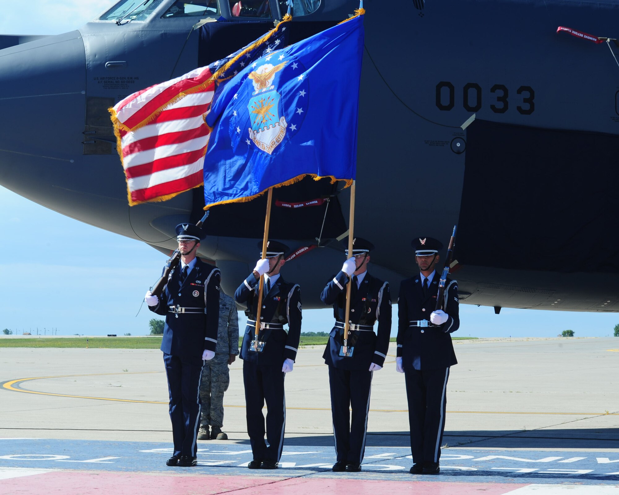 MINOT AIR FORCE BASE, N.D. -- Members of Minot Air Force Base Honor Guard present the colors during the 50th anniversary of the B-52H Stratofortess’s arrival to Minot here Aug. 19. The B-52, named the “Peace Persuader,” had nostalgic nose art painted on the airframe to commemorate the history of the aircraft. (U.S. Air Force photo/Senior Airman Michael J. Veloz)