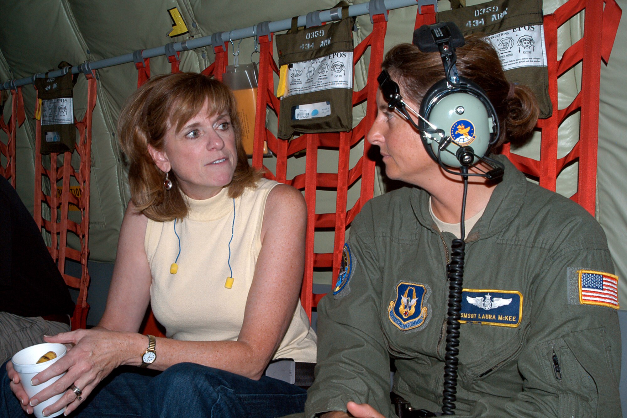 GRISSOM AIR RESERVE BASE, Ind. -- Senior Master Sgt. Laura McKee, 72nd Air Refueling Squadron boom operator, talks with Indiana state Rep. Peggy Welch on board a KC-135R Stratotanker during a refueling flight Aug. 17. Indiana state legislators visited Grissom to learn about the base and flew aboard a KC-135 to observe an aerial refueling with an RC-135 in order to witness first-hand the mission of the 434th Air Refueling Wing. (U.S. Air Force photo/Senior Airman Andrew McLaughlin)                                