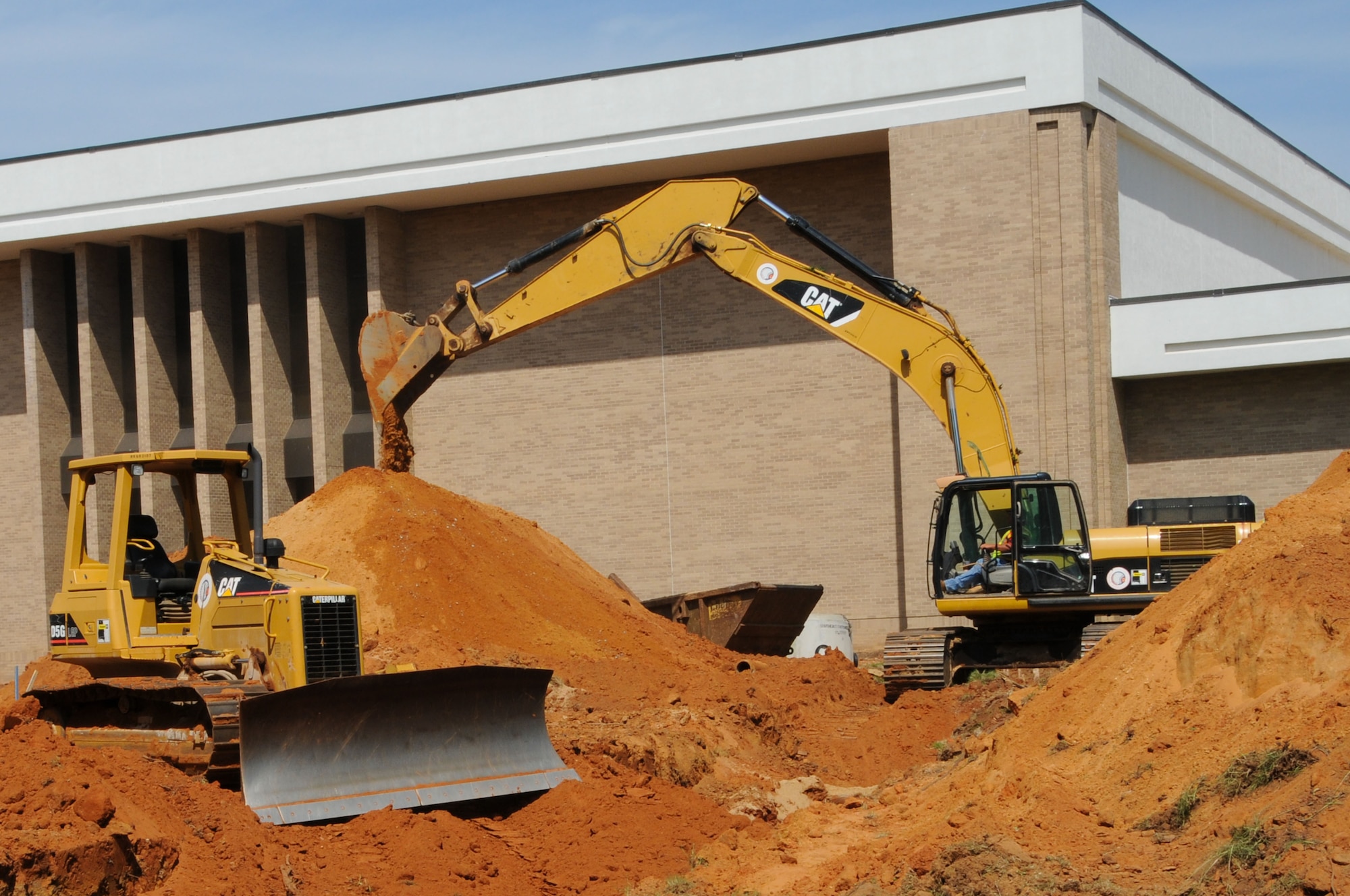 Crews work external construction for expansion and renovation of Muir S. Fairchild Research Information Center. Although the outside of the facility is currently awash in mounds of red clay, activities inside the library are continuing as usual. (Air Force photo/Chris Baldwin)