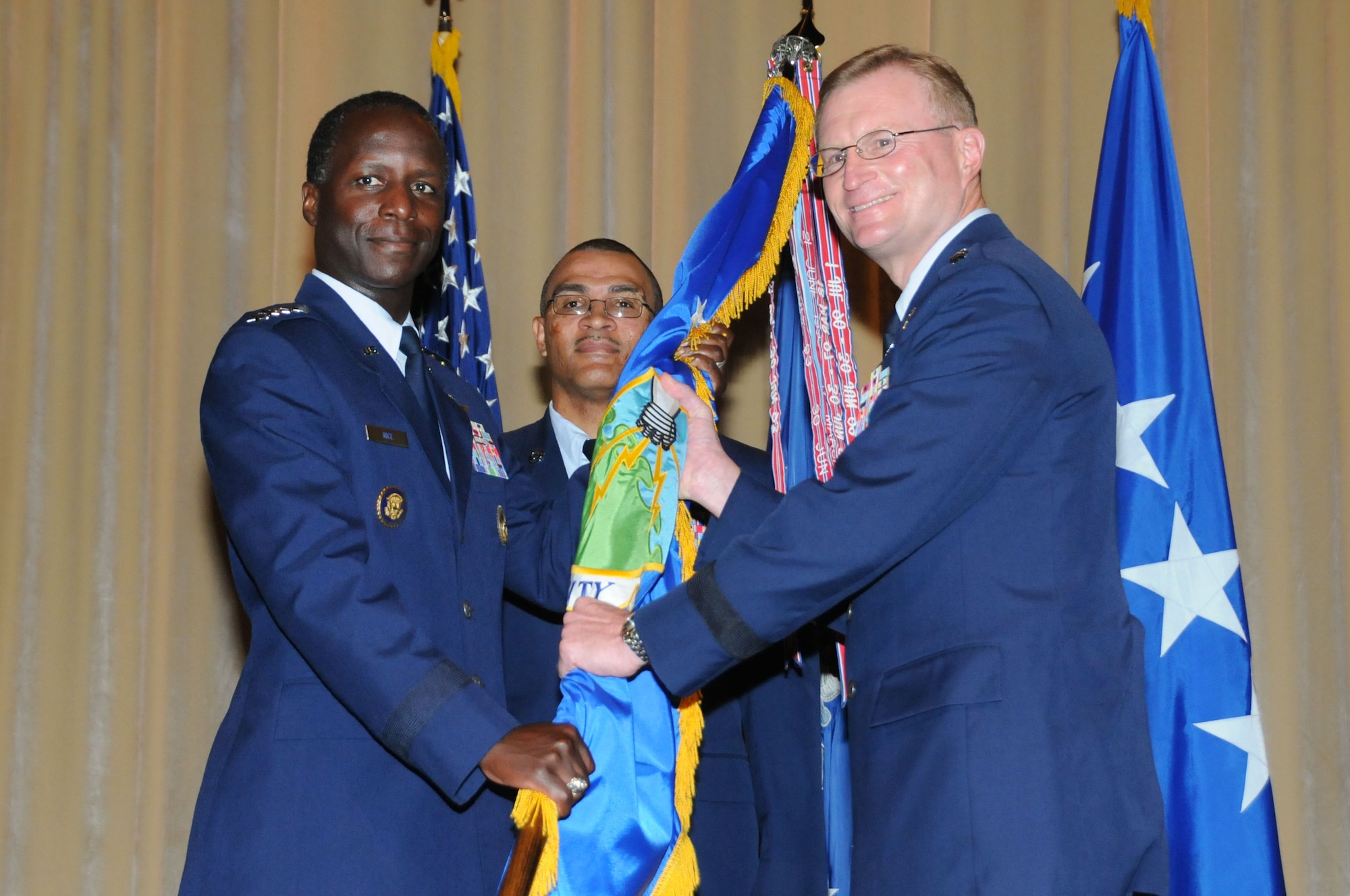 Air Education and Training Command Commander Gen. Edward Rice Jr. hands the Air University guidon to Lt. Gen. David Fadok, new Air University commander and president, during a change of command ceremony Aug. 12. (Air Force photo/Chris Baldwin)