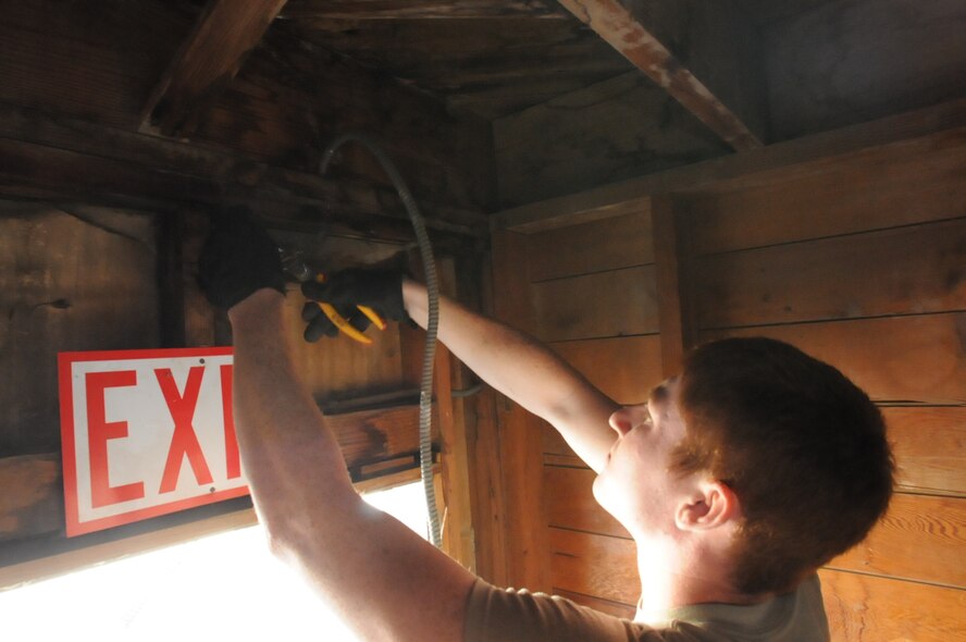 Staff Sgt. Nicholas Neitzel, an electrician with the 126th Civil Engineering Squadron, Illinois Air National Guard, wires up a replacement exterior light during a building renovation at Camp Roberts, Calif. The Army National Guard training base was created in 1941 to support troops leaving for World War II and is now in need of repairs to buildings and infrastructure. Air National Guard Civil Engineering squadrons, known as "Prime Beef" units when deployed, are using the opportunity to train on real world electrical, structural, plumbing and heavy equipment scenarios. This creates a  collaboration that proves valuable to both National Guard components.