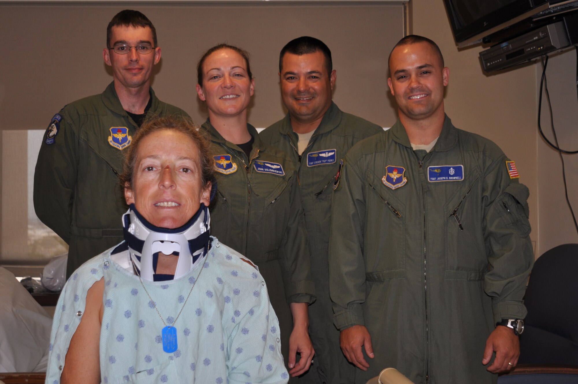 Paulette Kirby sits on her bed at Sacred Heart Medical Center in Spokane, Wash., Aug. 18 surrounded by the Fairchild four-man helicopter crew who rescued her from Thompson Pass, Idaho the day before. Pictured from left to right from the 36th Rescue Flight are: (Capt. John Alsbrooks, Capt. Jennifer Golembiewski, Tech. Sgt. Steven Perez and Tech. Sgt. Joseph Brownell). This is the 36th RQF’s 663rd rescue. (U.S. Air Force photo/Scott King)    