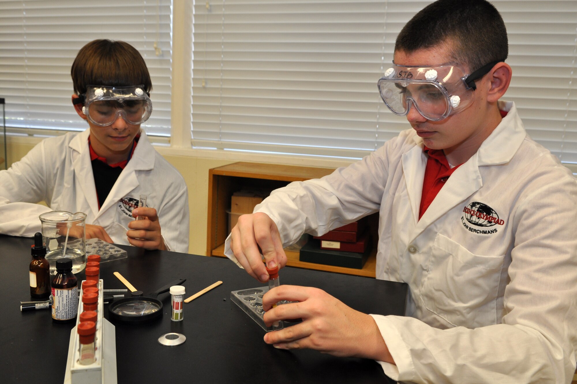 Nick Henderson and Matthew Vitacca participate in an exercise called “Crime Busters” at St. John Berchmans Catholic School in Shreveport, La., Aug. 17, 2011. The exercise, which produces fake crimes scenarios, is designed for the students to learn how to test certain substances such as powders, metals and liquids. Nick and Matthew are students at St. John Berchmans Catholic School and participated in the STARBASE Louisiana program at Barksdale Air Force Base, La., when they were 5th Graders.  The STARBASE program, which is supported by the 307th Bomb Wing, presents an exciting 25-hour hands on/minds on aviation and aerospace curriculum to area 5th grade students and their teachers. The DoD program is committed to addressing the critical needs in STEM education - Science, Technology, Engineering and Mathematics. STARBASE Louisiana introduces its students to exciting STEM education topics, inspiring these young minds to further explore these topics in future course work. (Courtesy photo by Jeff Walston) 