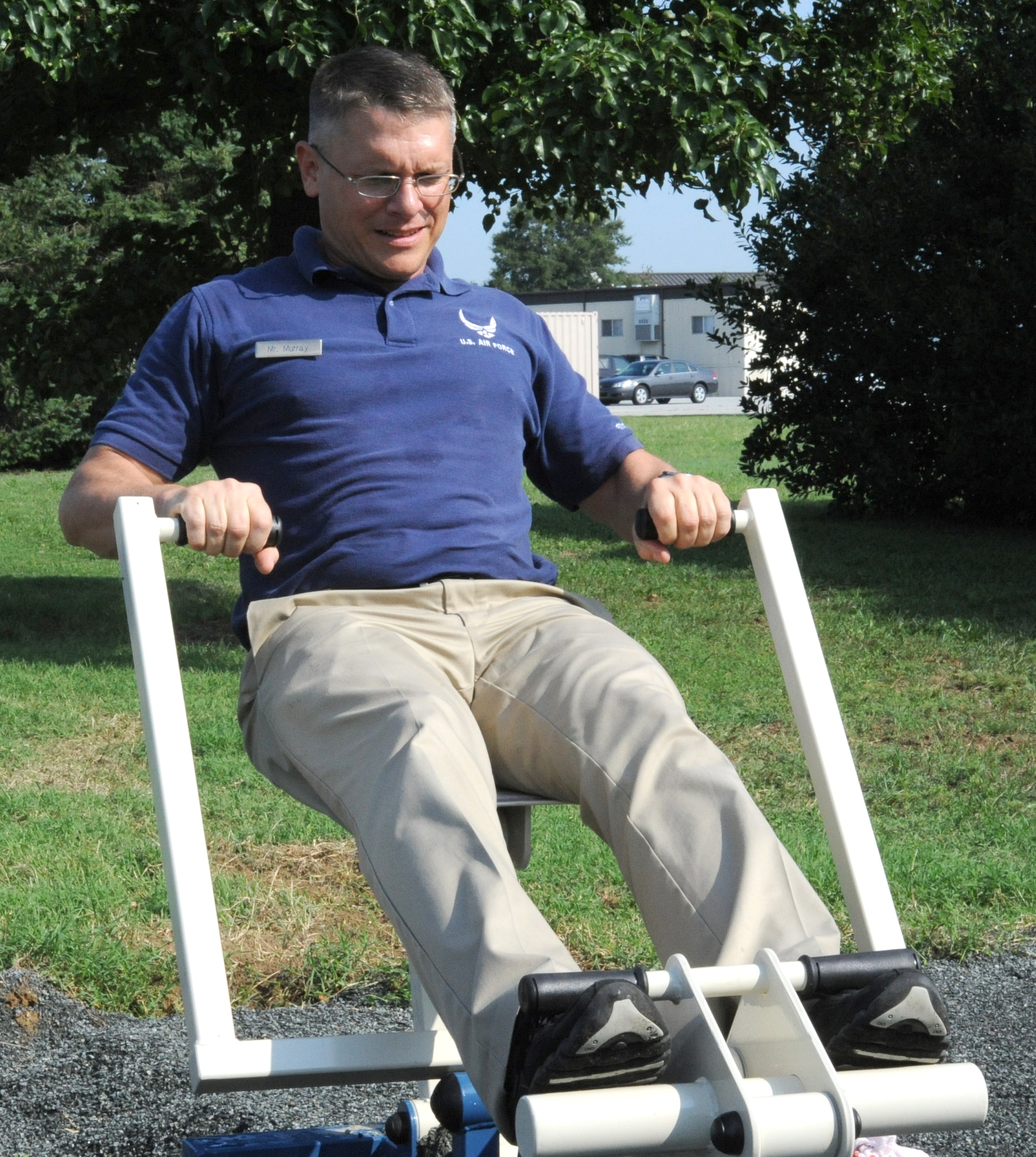 John Murray, a fitness program manager with the 436th Force Support Squadron, tests a new rowing machine on the running path Aug. 19.  The rowing machine is one of nine new machines recently installed along the running path behind The Landings Club to provide a better outdoor workout for service members.  (U.S. Air Force photo by Staff Sgt. Chad Padgett)