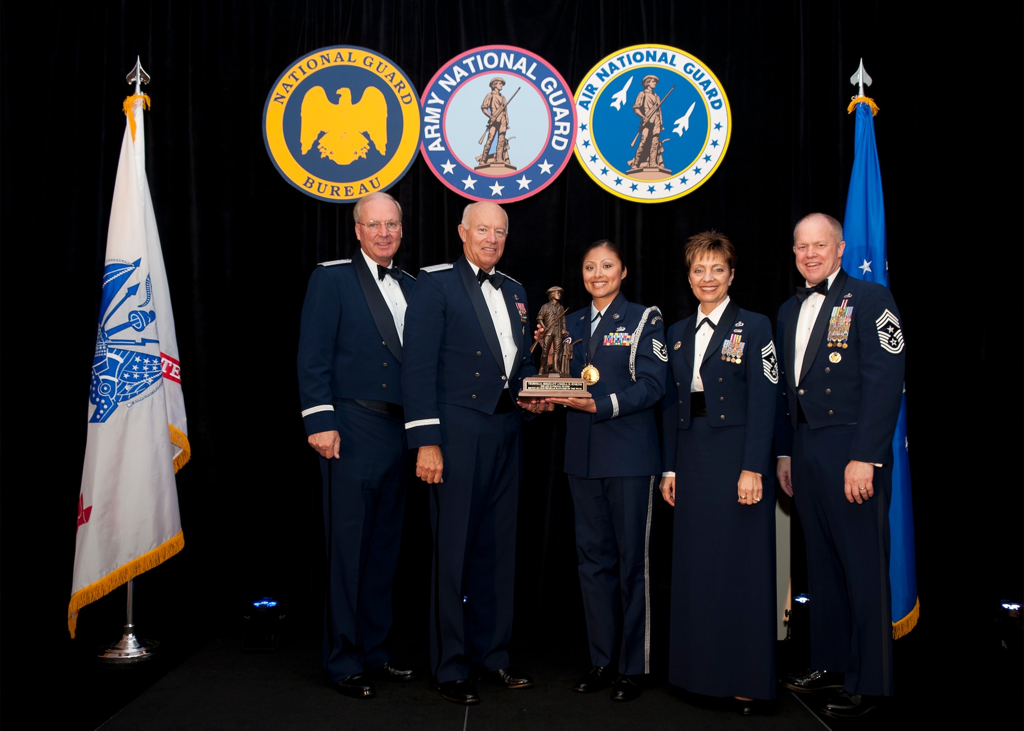 Technical Sergeant Angel M. Jenkins, a Knowledge Operations Manager assigned to the 149th Mission Support Group, Lackland Air Force Base, Texas is named Air National Guard Base Honor Guard Manager of the Year for 2011. The award was presented at the Outstanding Soldiers and Airmen of the Year banquet in Arlington Virginia. Presenting the award are (left to right) General Craig R. McKinley, Chief, National Guard Bureau, Leiutenant General Harry M. Wyatt III, Director Air National Guard, Chief Master Sergeant Denise M. Jelinski-Hall, Senior Enlisted Leader for the National Guard Bureau, and Chief Master Sergeant Christopher E. Muncy, Command Chief Master of the National Guard. (USAF Photo by MSgt Marvin R. Preston, 169th FW/PA) 