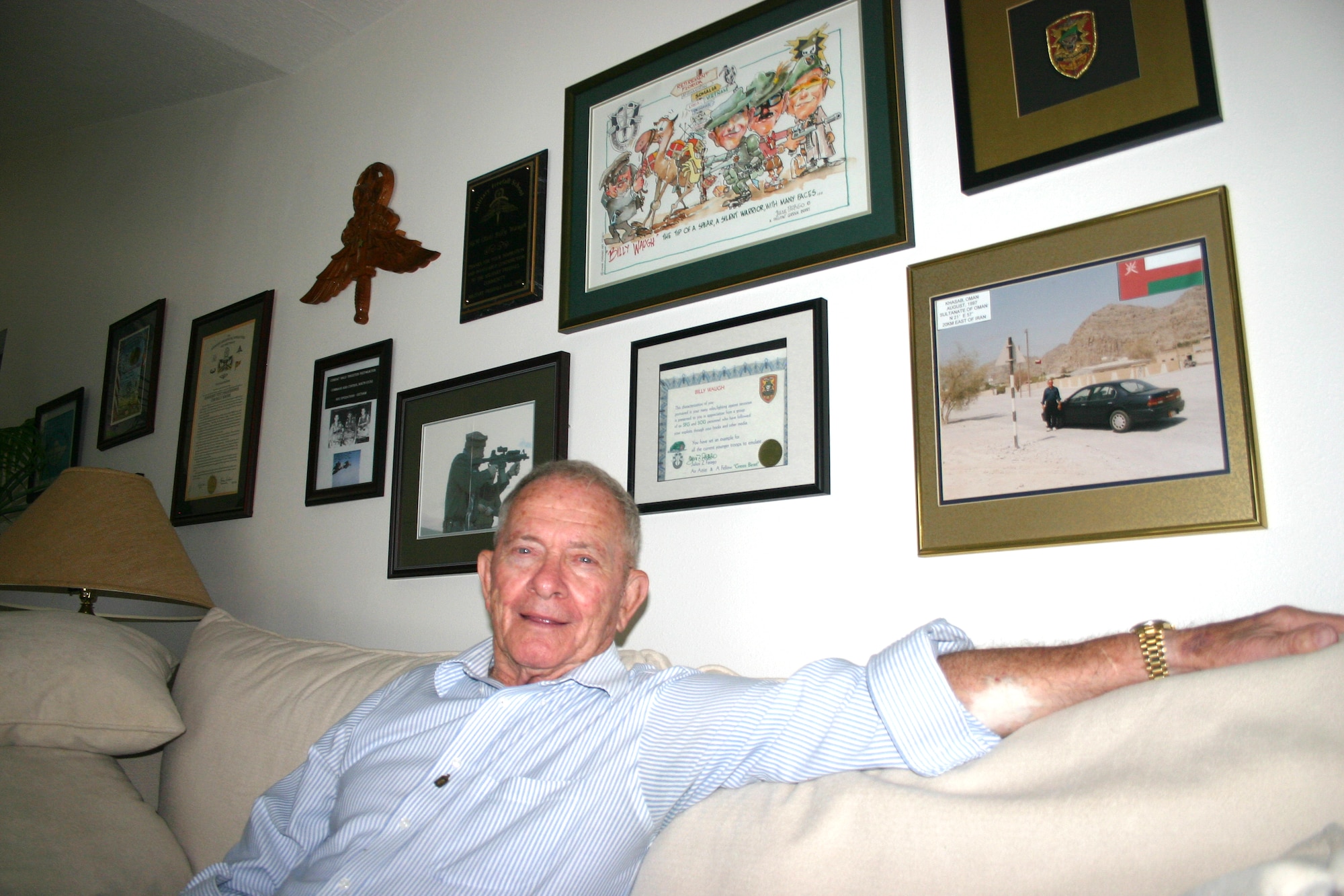 Billy Waugh relaxing at home. Behind him are photos and other memorabilla from his years of military and CIA service. (US Air Force photo by Nick Stubbs)