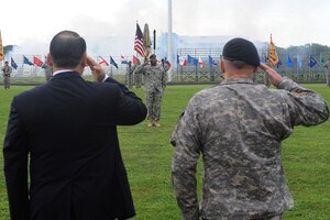 Davis D. Tindoll, Installation Management Command Atlantic Region director, and Lt. Gen. Rick Lynch, Installation Management Command and assistant chief of staff for installation management, salute while the 7th Sustainment Brigade color guard honors the nation during the color uncasing ceremony Aug. 11 at the Murphy Field Sports Complex on Fort Eustis. The uncasing of the colors symbolizes the establishment of Installation Management Command Atlantic Region as a consolidation of Northeast Region, headquartered at Fort Monroe, and Southeast Region, headquartered at Fort McPherson, Ga. (U.S. Air Force photo by Staff Sgt. Antoinette Gibson)