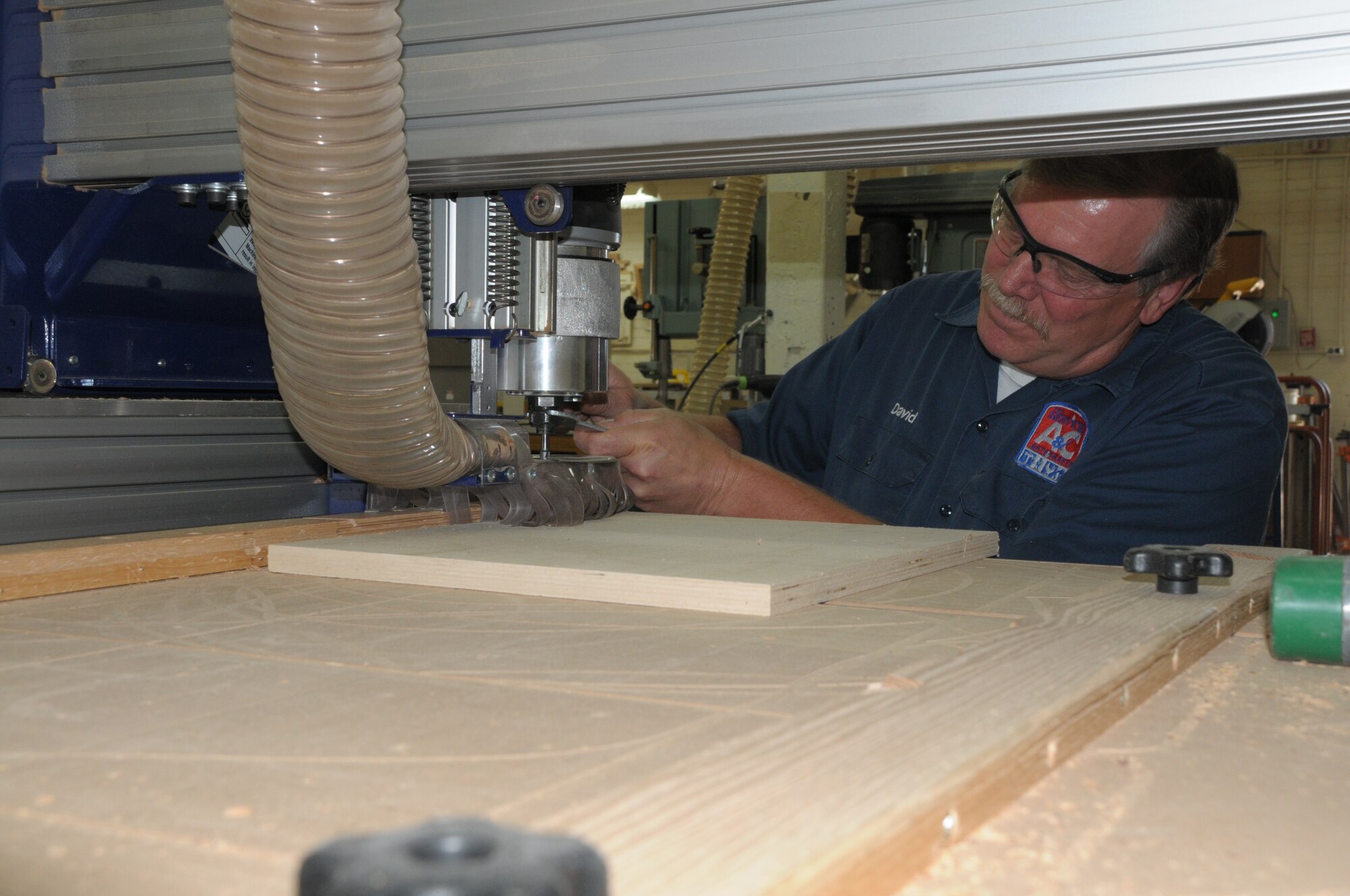 Master woodcrafter David Holmquist, 90th Force Support Squadron, tightens a wood bit for the digital rotor used to make exquisite wood products for his customers. Other classes the arts and crafts center offer include leather working, sewing, sculpting and more. For more information about the arts and crafts center call 773-3754 or 773-3166. (U.S. Air Force photo by Blaze Lipowski)