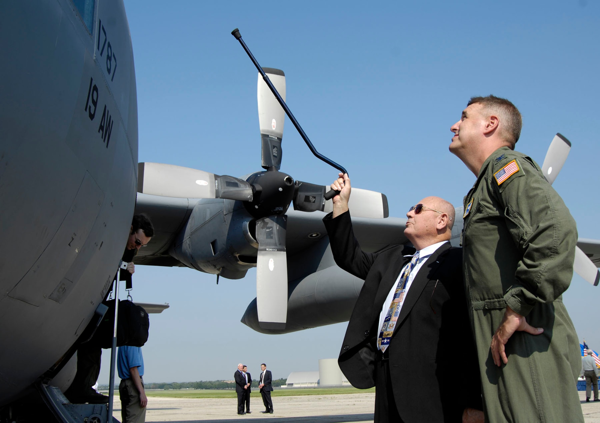 DAYTON, Ohio -- C-130E SPARE 617 made its final flight to the National Museum of the U.S. Air Force on Aug. 18, 2011. Here, Col. Michael A. Minihan (right), commander of the 19th Airlift Wing, talks about the C-130E with Col. (Ret.) William Caldwell, who received the Air Force Cross while piloting the aircraft during the Southeast Asia War. (U.S. Air Force photo by Michelle Gigante)