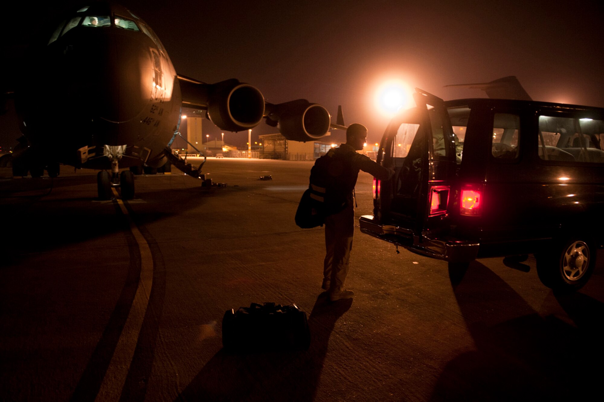 Capt. Eric Bowers, an 817th Expeditionary Airlift Squadron pilot, unloads flight equipment from a C-17 Globemaster III aircraft into a van after a flight Aug. 18, 2011, at Incirlik Air Base, Turkey. The crew transported equipment and supplies from Incirlik to Kandahar Air Field, Afghanistan. (U.S. Air Force photo by Tech. Sgt. Michael B. Keller/Released)