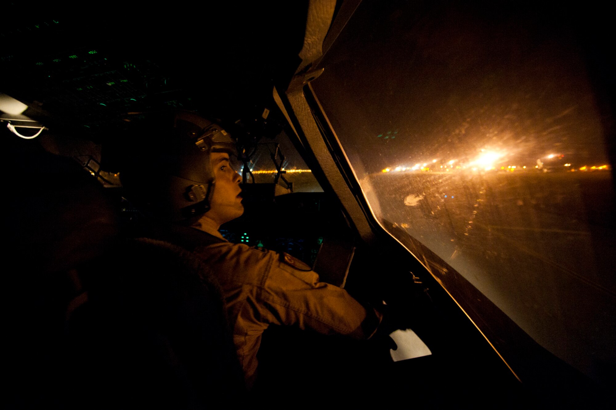 Capt. Eric Bowers, an 817th Expeditionary Airlift Squadron pilot, opens his window to clear condensation after landing a C-17 Globemaster III aircraft Aug. 18, 2011, at Incirlik Air Base, Turkey. The crew transported equipment and supplies from Incirlik to Kandahar Air Field, Afghanistan. (U.S. Air Force photo by Tech. Sgt. Michael B. Keller/Released)