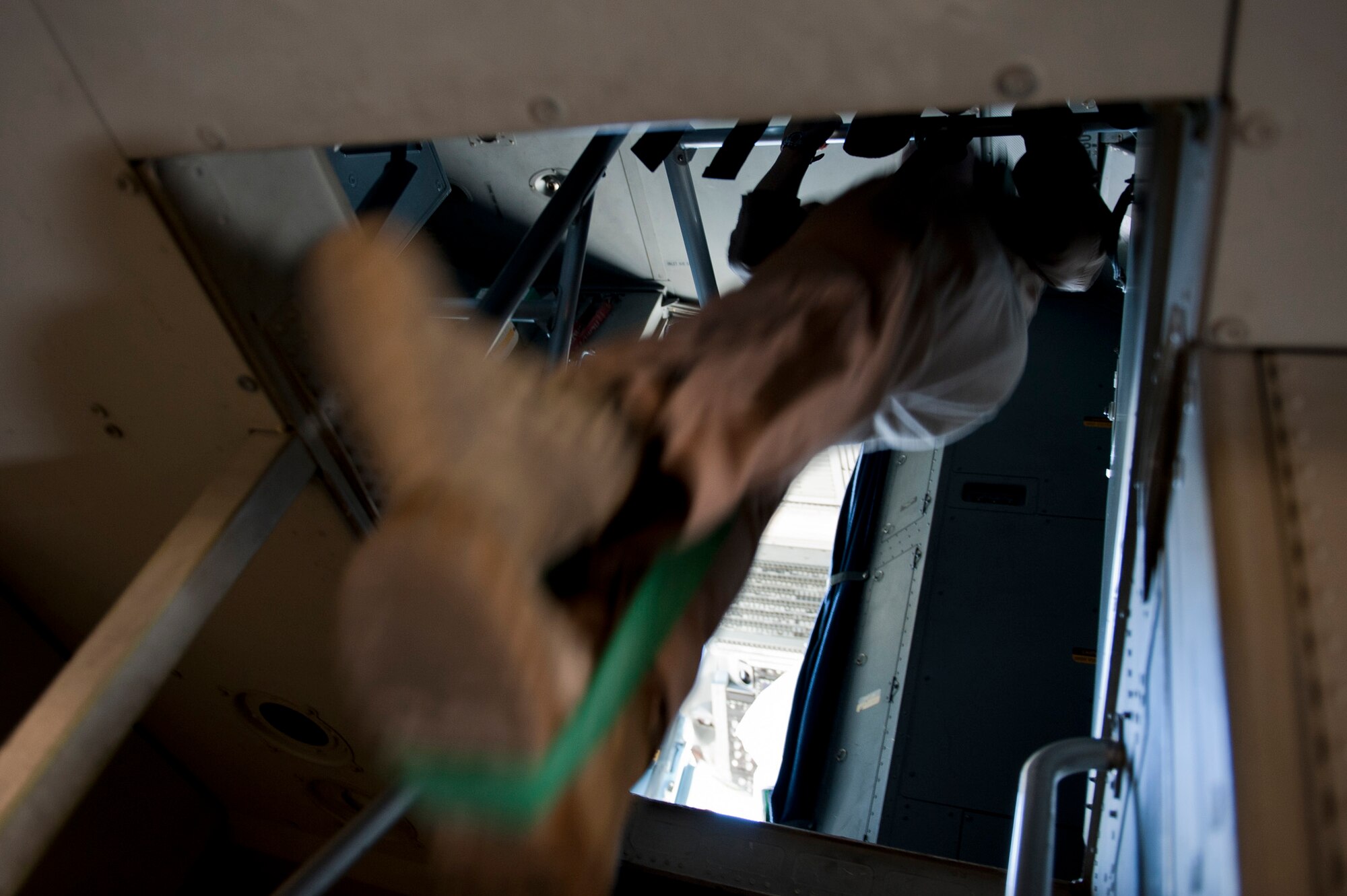 Staff Sgt. Melissa Butterfield, an 817th Expeditionary Airlift Squadron loadmaster, does pull-ups with the help of a rubber band onboard a C-17 Globemaster III aircraft Aug. 18, 2011, while flying over Afghanistan. The crew transported equipment and supplies from Incirlik Air Base, Turkey, to Kandahar Air Field, Afghanistan. (U.S. Air Force photo by Tech. Sgt. Michael B. Keller/Released)